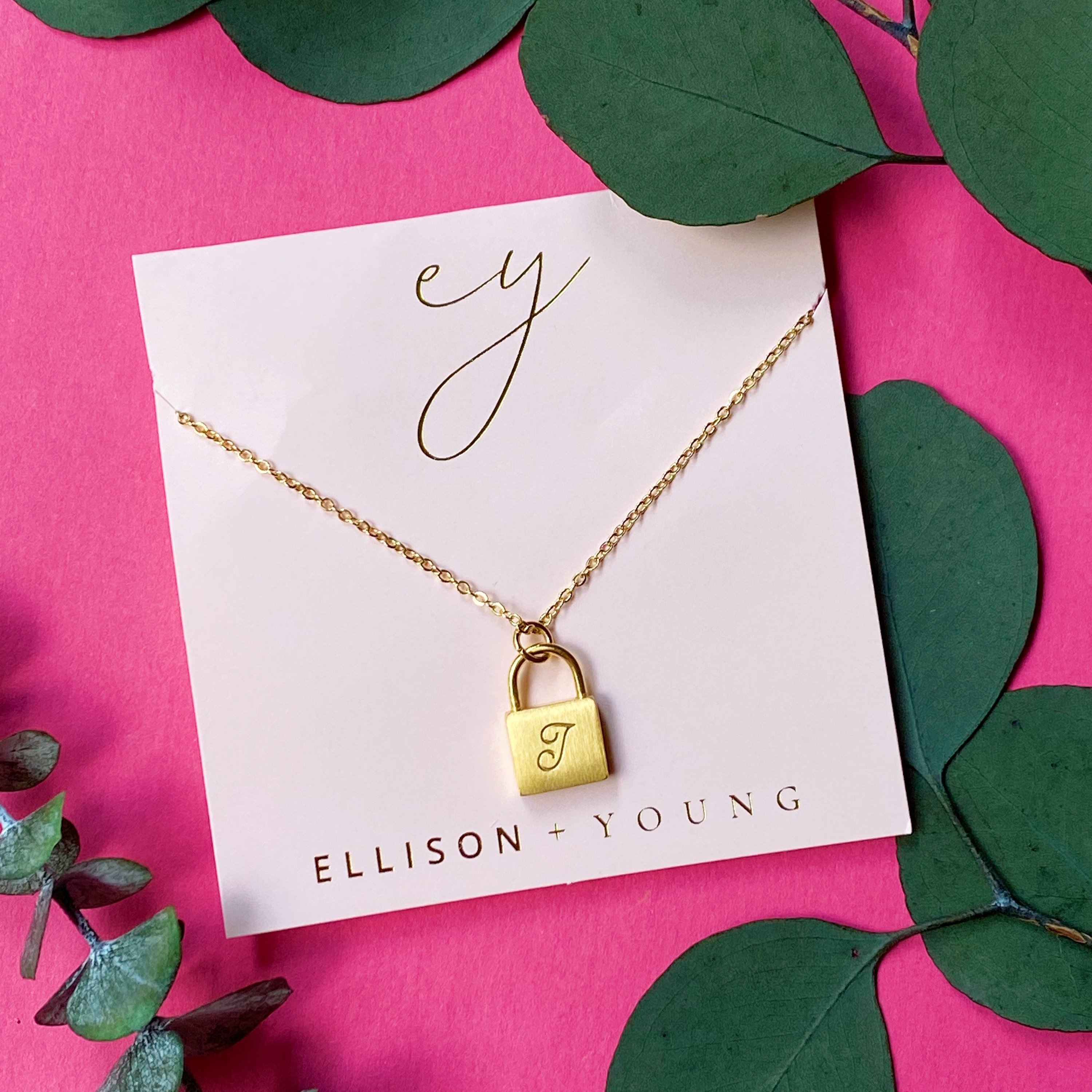 Elegant Scripted Notes Locket Initial Necklace with brushed finish and monogram initial.