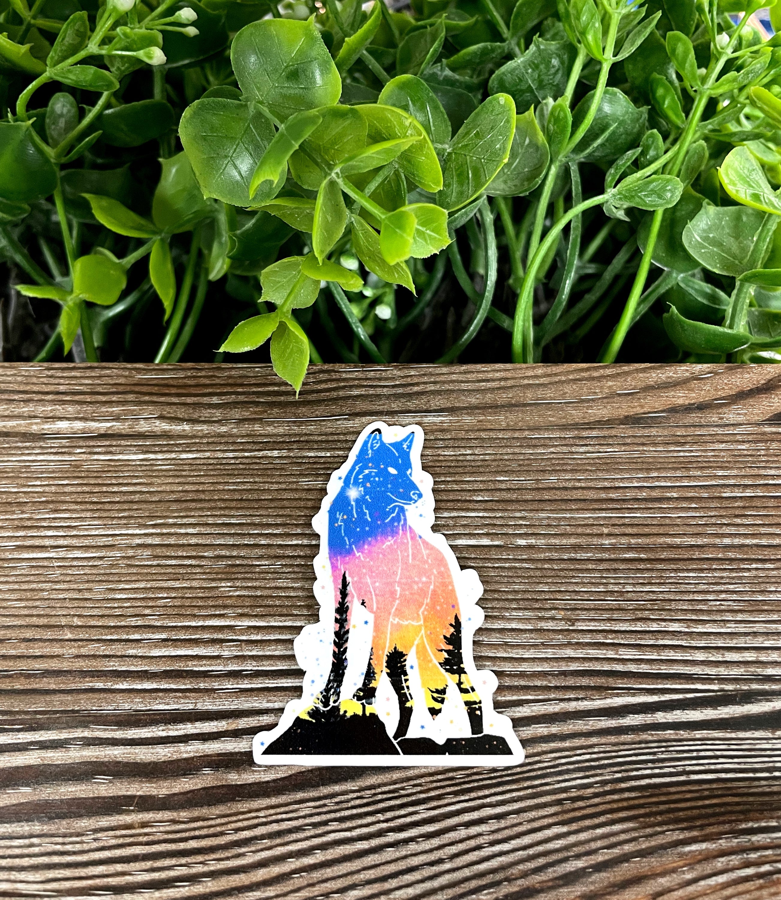 Standing Galaxy Wolf Silhouette die cut vinyl sticker on a smooth surface, showcasing vibrant colors and intricate design.