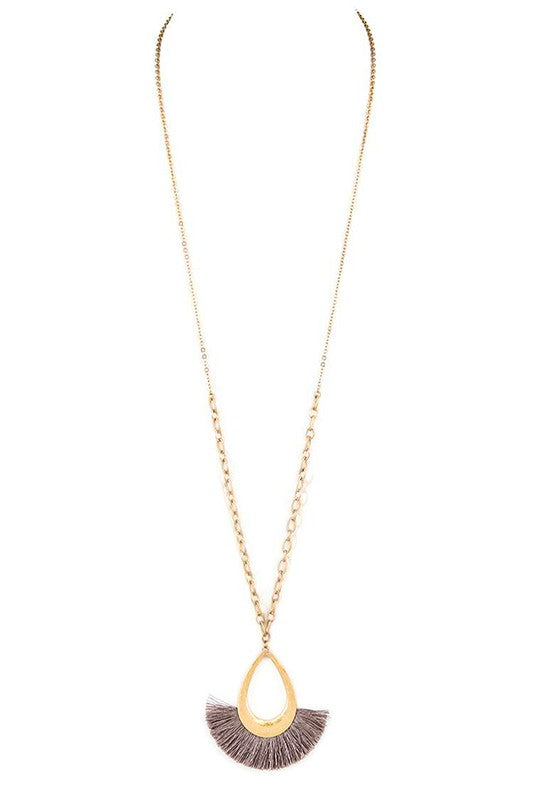 A stylish tassel teardrop pendant necklace featuring a long chain, perfect for adding elegance to any outfit.