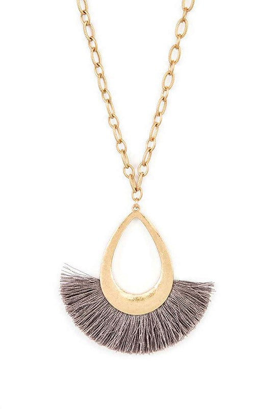 A stylish tassel teardrop pendant necklace featuring a long chain, perfect for adding elegance to any outfit.