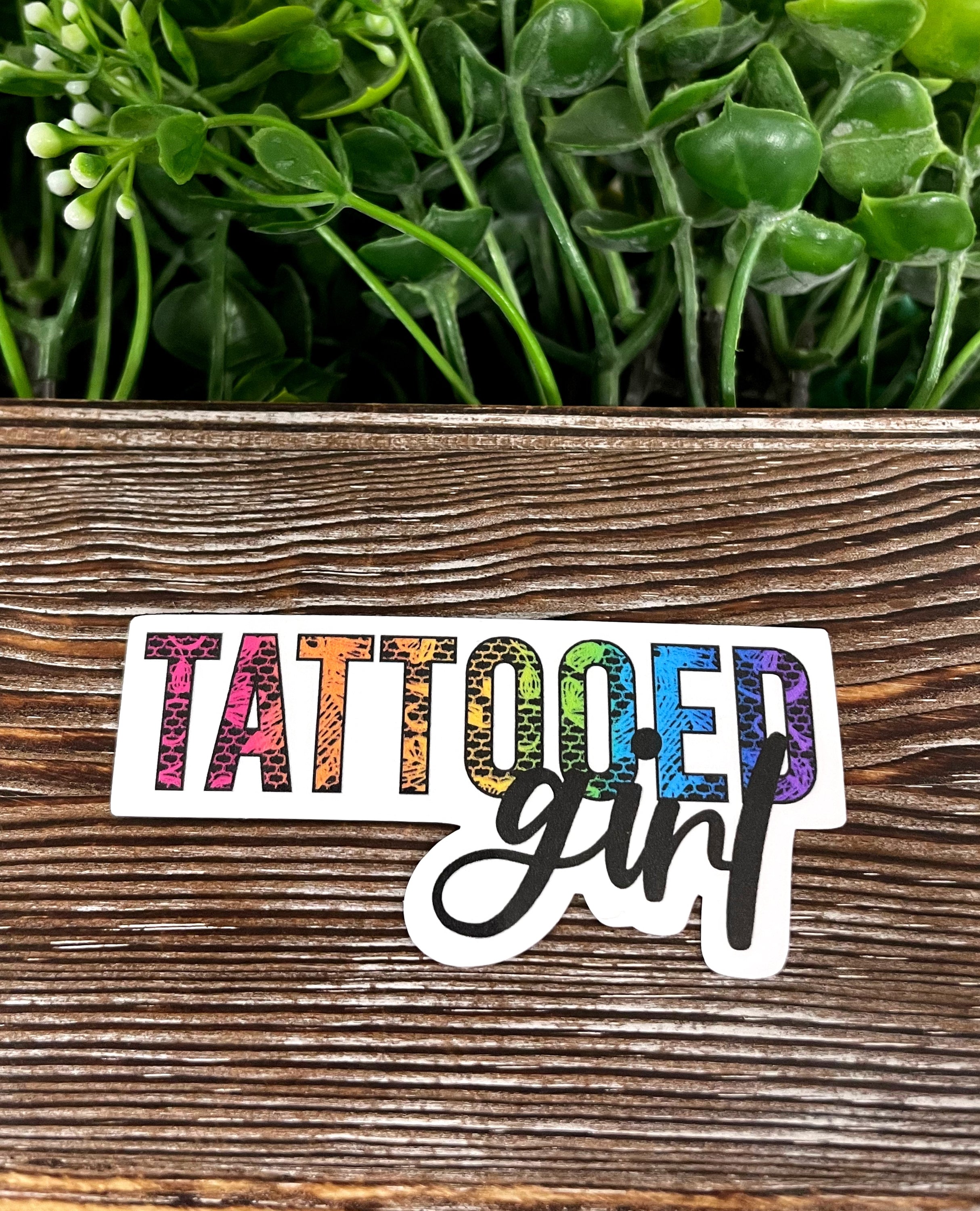 Tattooed girl die cut vinyl sticker in bold colors, showcasing vibrant design on a smooth surface.