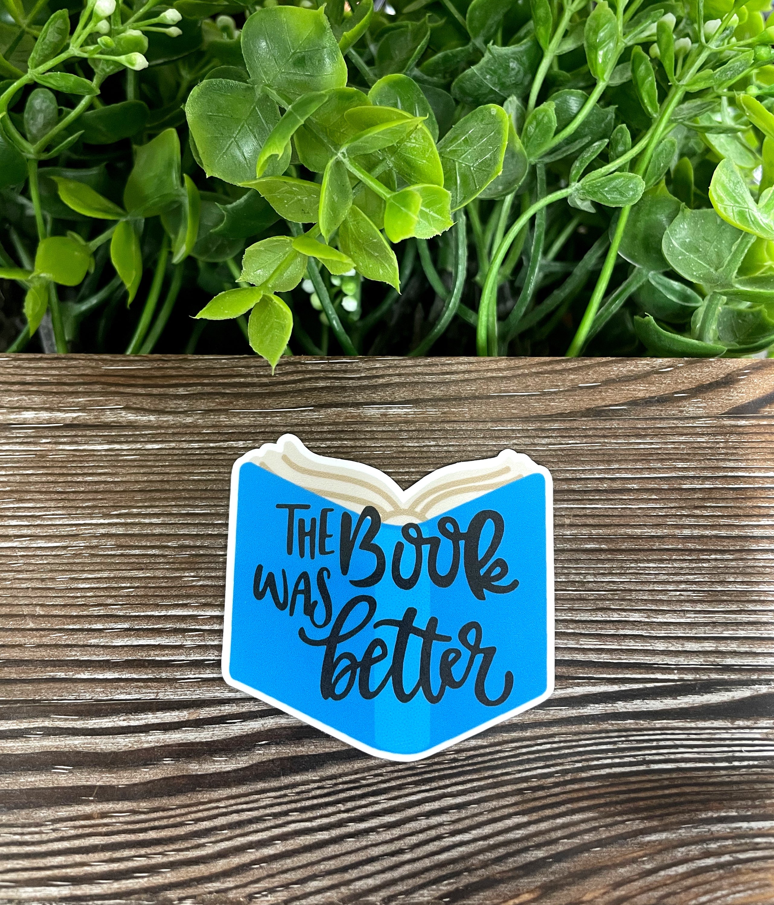 The Book was Better sticker featuring a stylish design, perfect for personalizing notebooks, water bottles, and more.