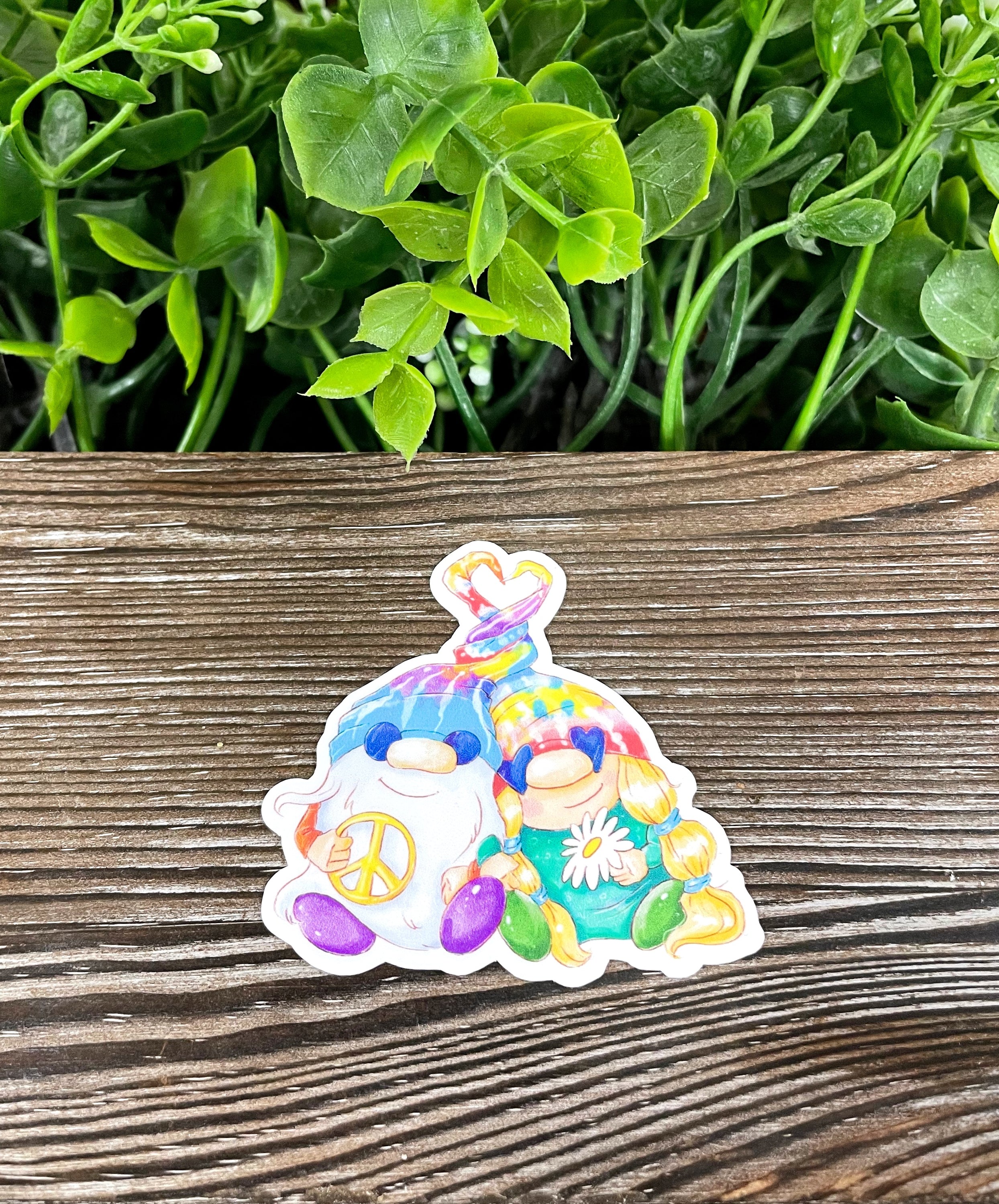 Colorful tie dye gnome sticker on a smooth surface, showcasing vibrant colors and intricate design.