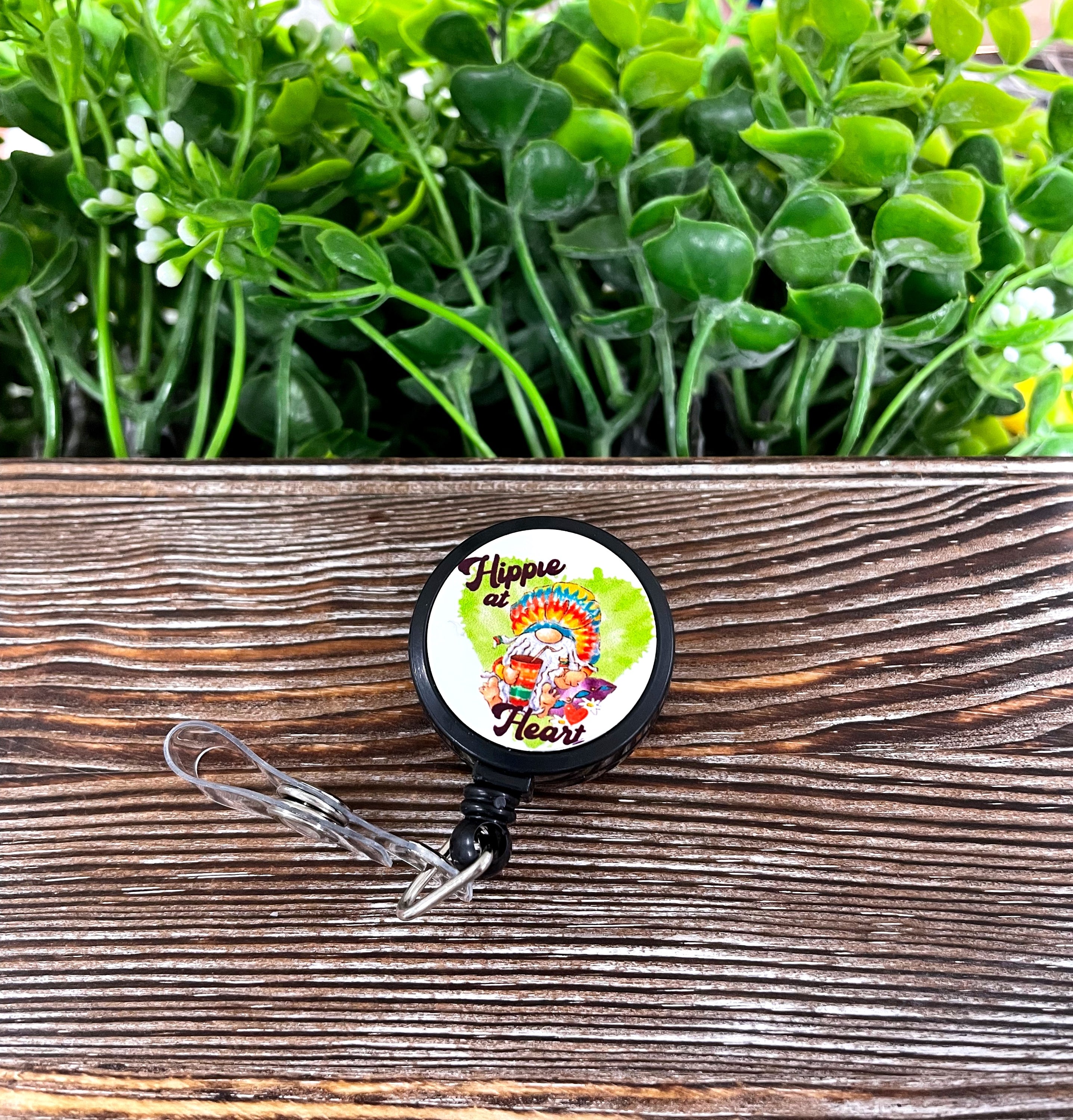 A vibrant tie-dye retractable badge reel featuring a bohemian design, measuring 1.2 inches in diameter with a 24-inch extension cord.