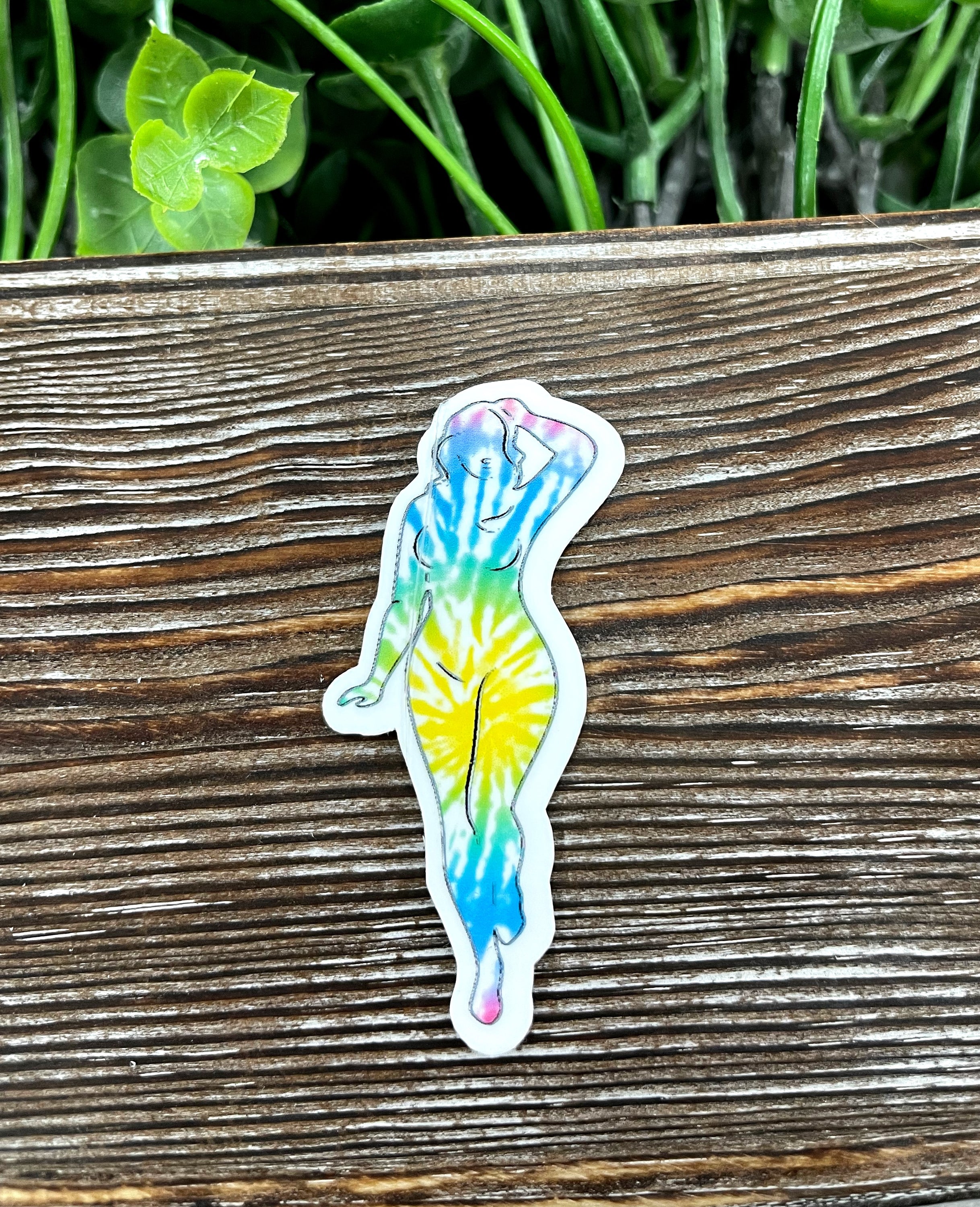 Colorful tie dye woman silhouette die cut sticker on a smooth surface, showcasing vibrant colors and intricate design.