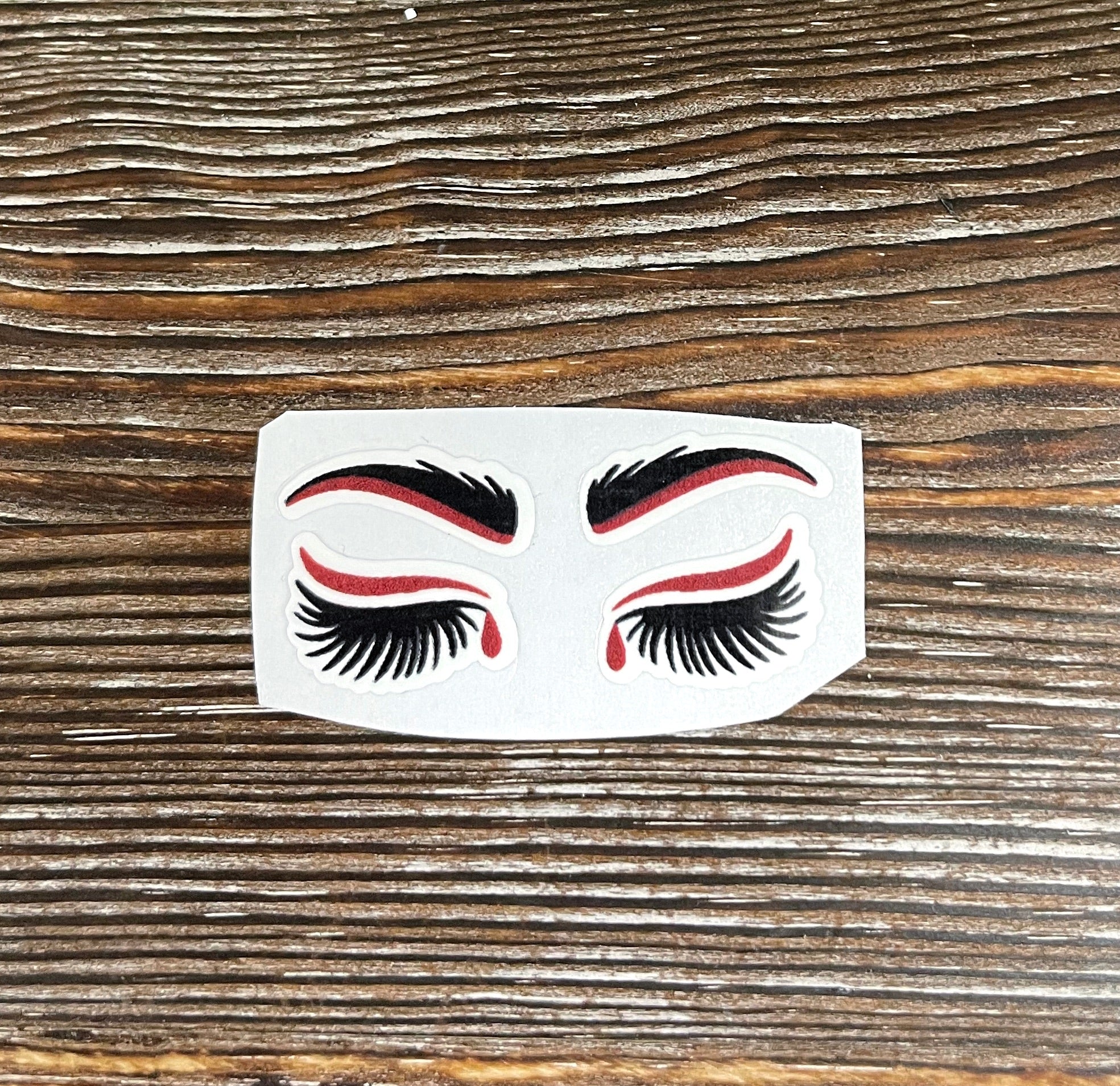 True Crime Blood Drop Eyes Die Cut Sticker featuring a bold graphic design with blood drop eyes, perfect for personalizing items.