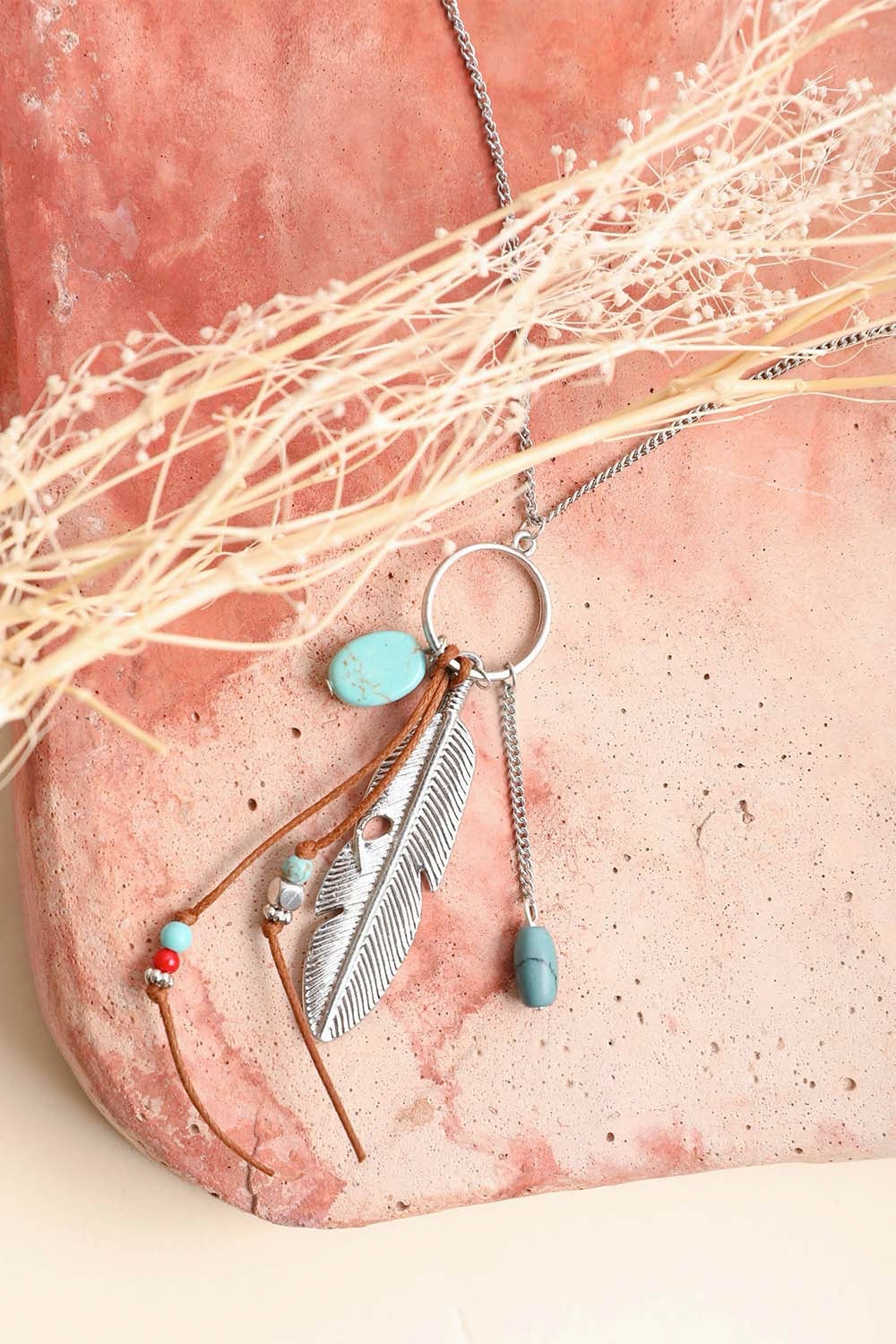 A stylish Turquoise Charm Necklace featuring playful charms and vibrant turquoise stones, perfect for modern women.