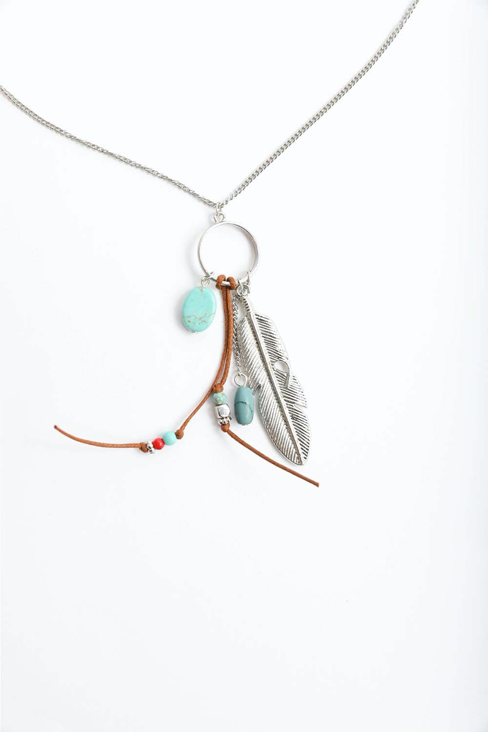 A stylish Turquoise Charm Necklace featuring playful charms and vibrant turquoise stones, perfect for modern women.