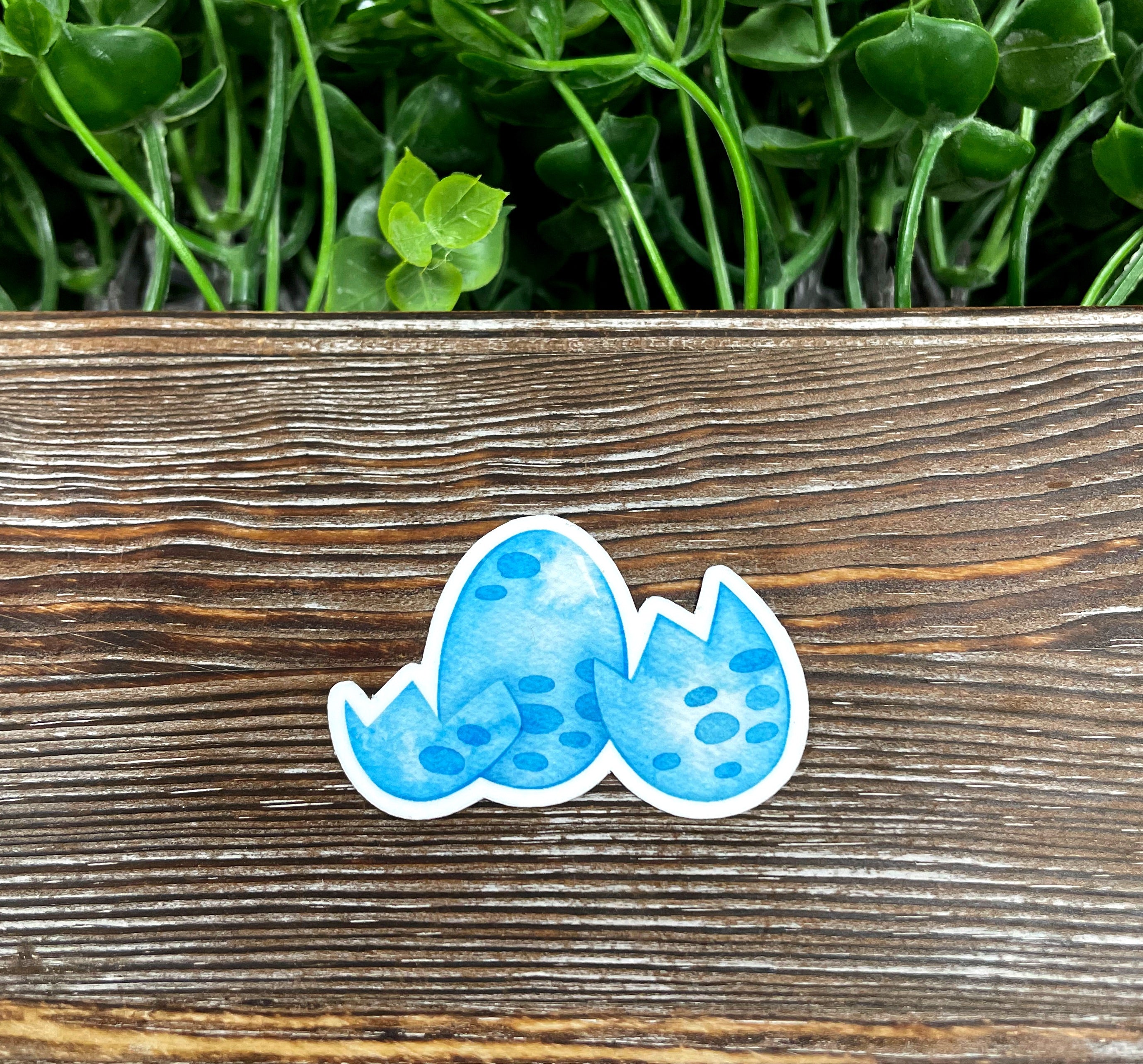 Watercolor Blue Dinosaur Eggs Sticker featuring vibrant colors and intricate design, perfect for personalizing various surfaces.