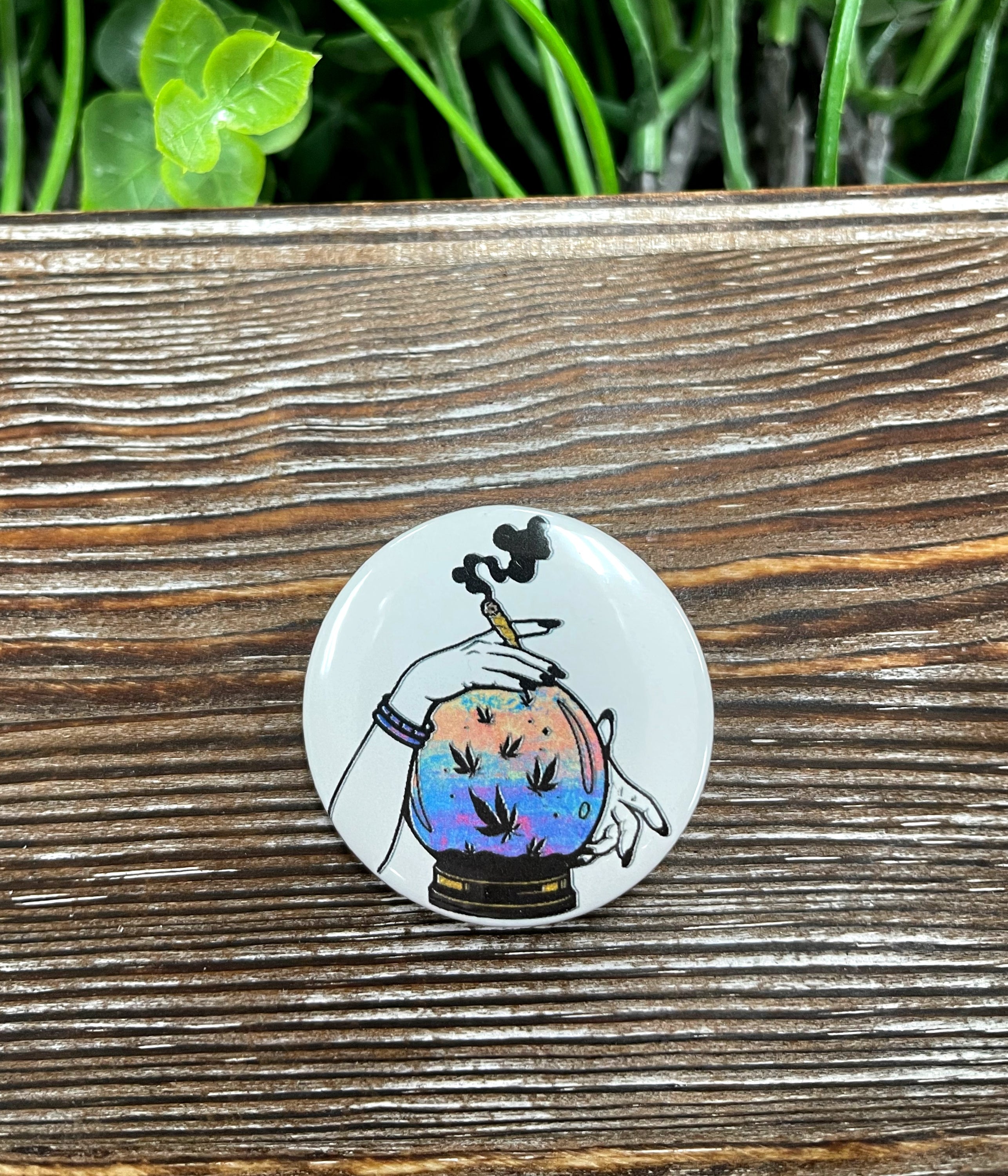 A colorful 1.25-inch button featuring a watercolor crystal ball smoker design, perfect for personal accessories.