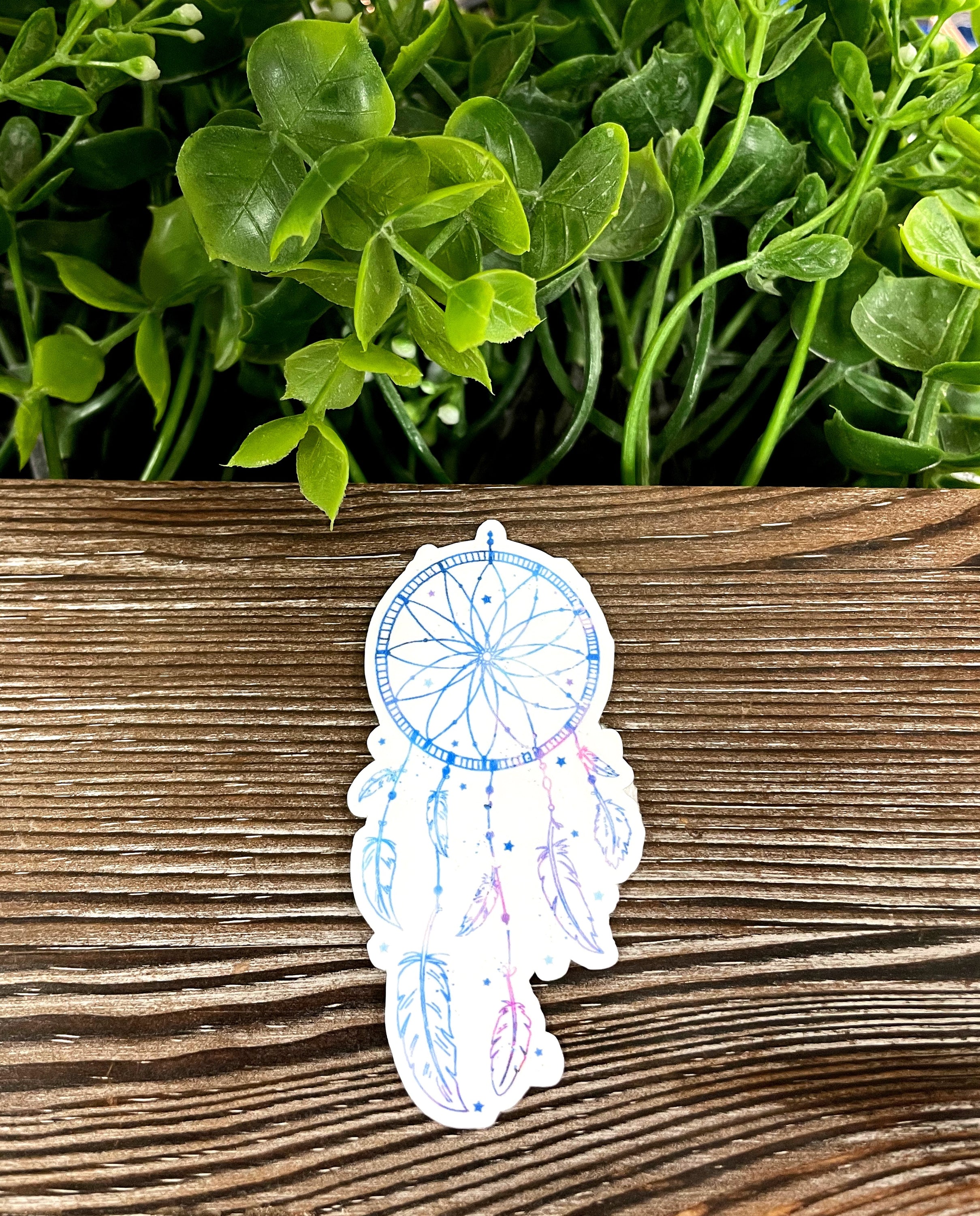 A vibrant watercolor dreamcatcher die cut vinyl sticker featuring colorful feathers, perfect for personalizing smooth surfaces.