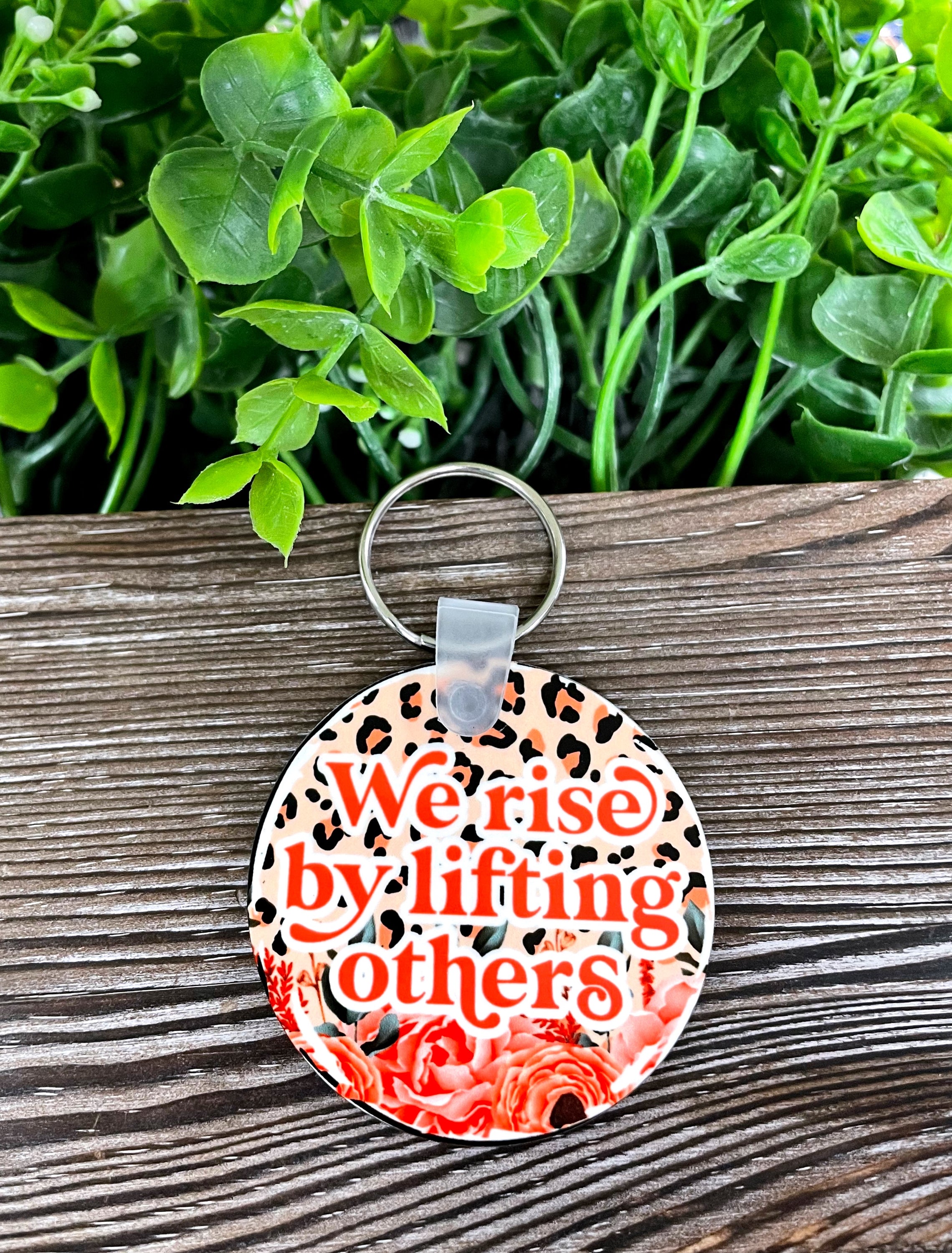 We Rise by Lifting Others MDF Round Keychain featuring a boho design, lightweight and colorful, perfect for personal expression.