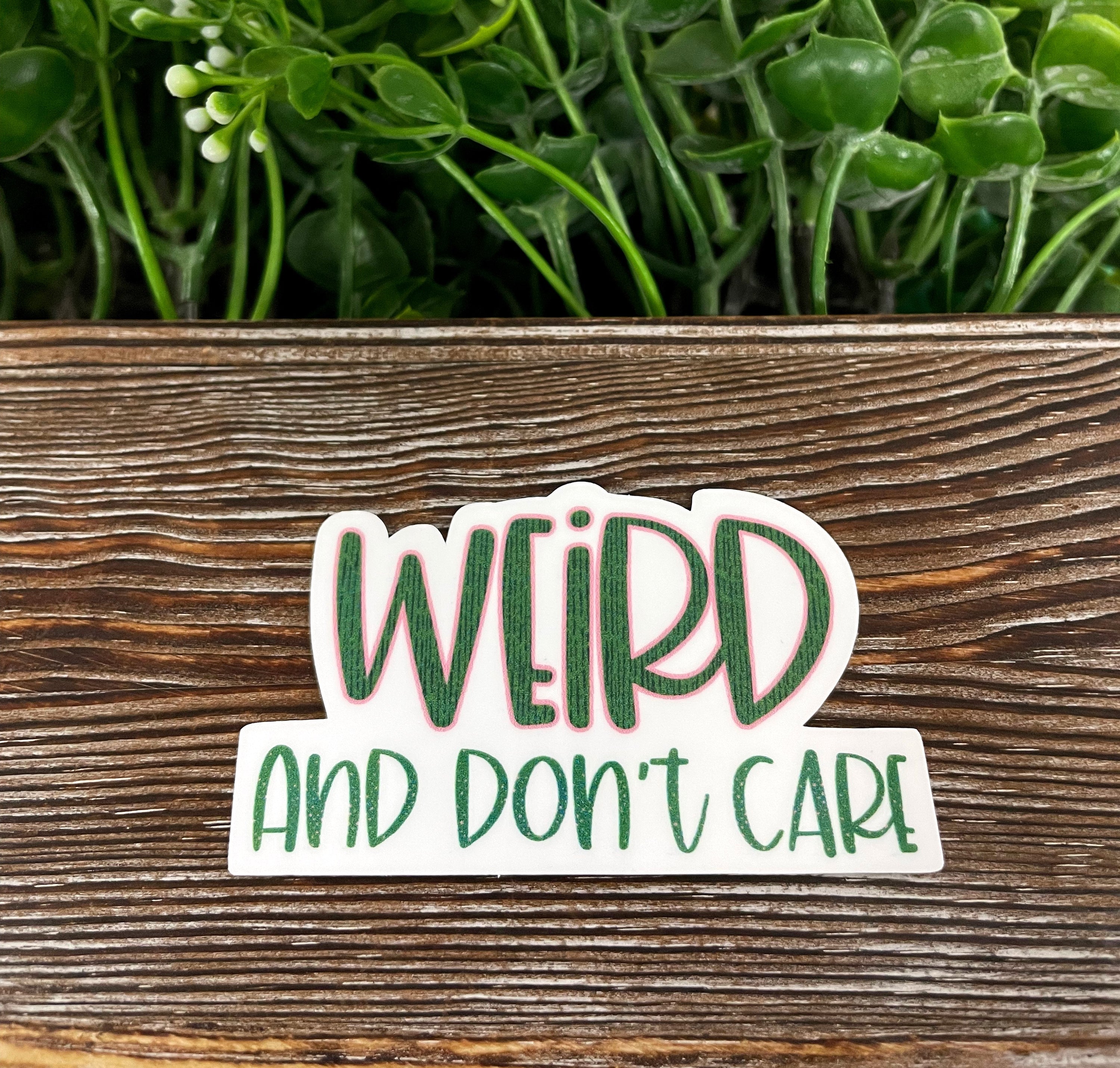 A vibrant Weird and Don't Care Sticker featuring unique designs, perfect for personalizing various surfaces like notebooks and water bottles.