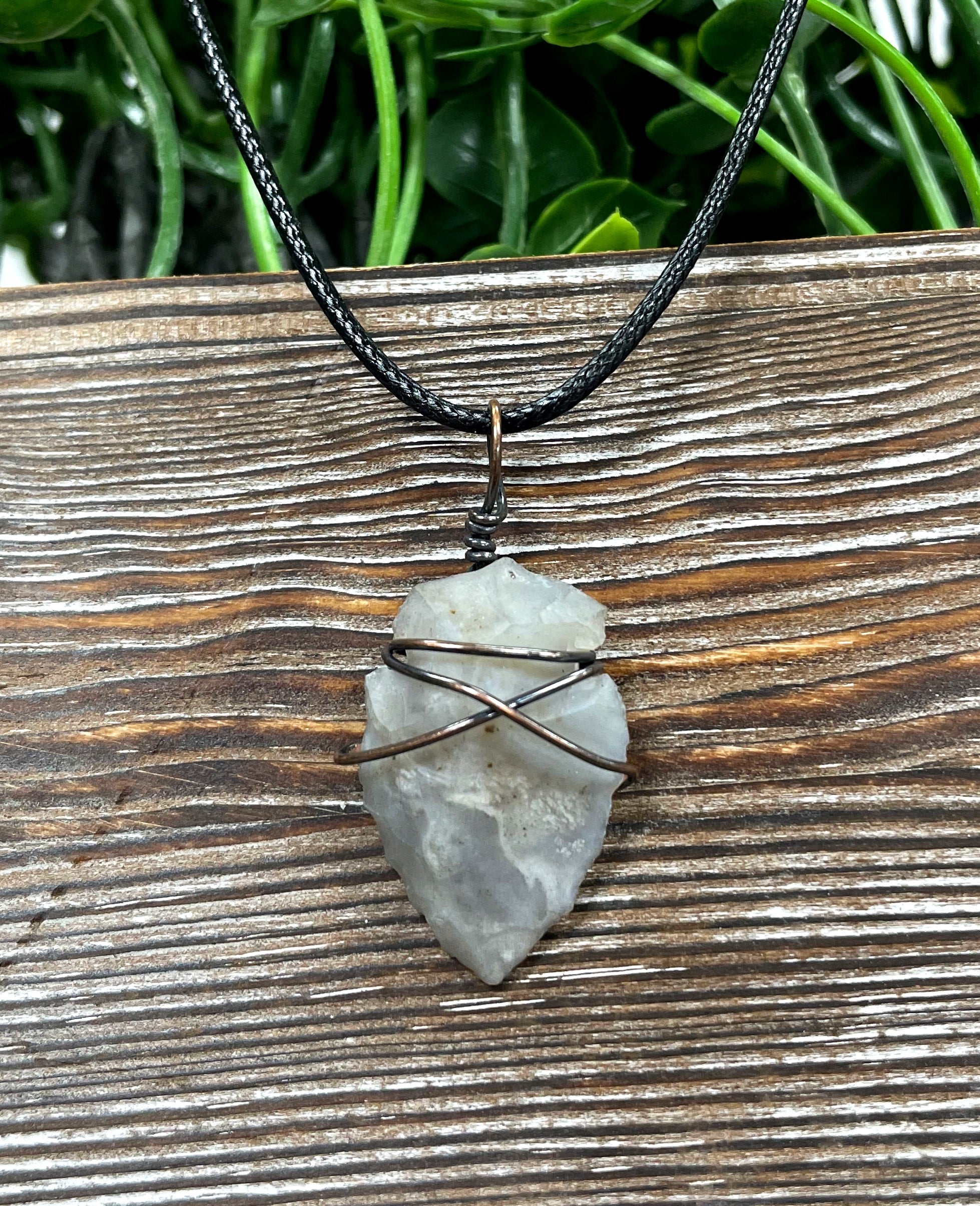 Wire Wrapped Arrowhead Pendant featuring oxidized copper wire on a 21-inch cord, showcasing an antique finish.