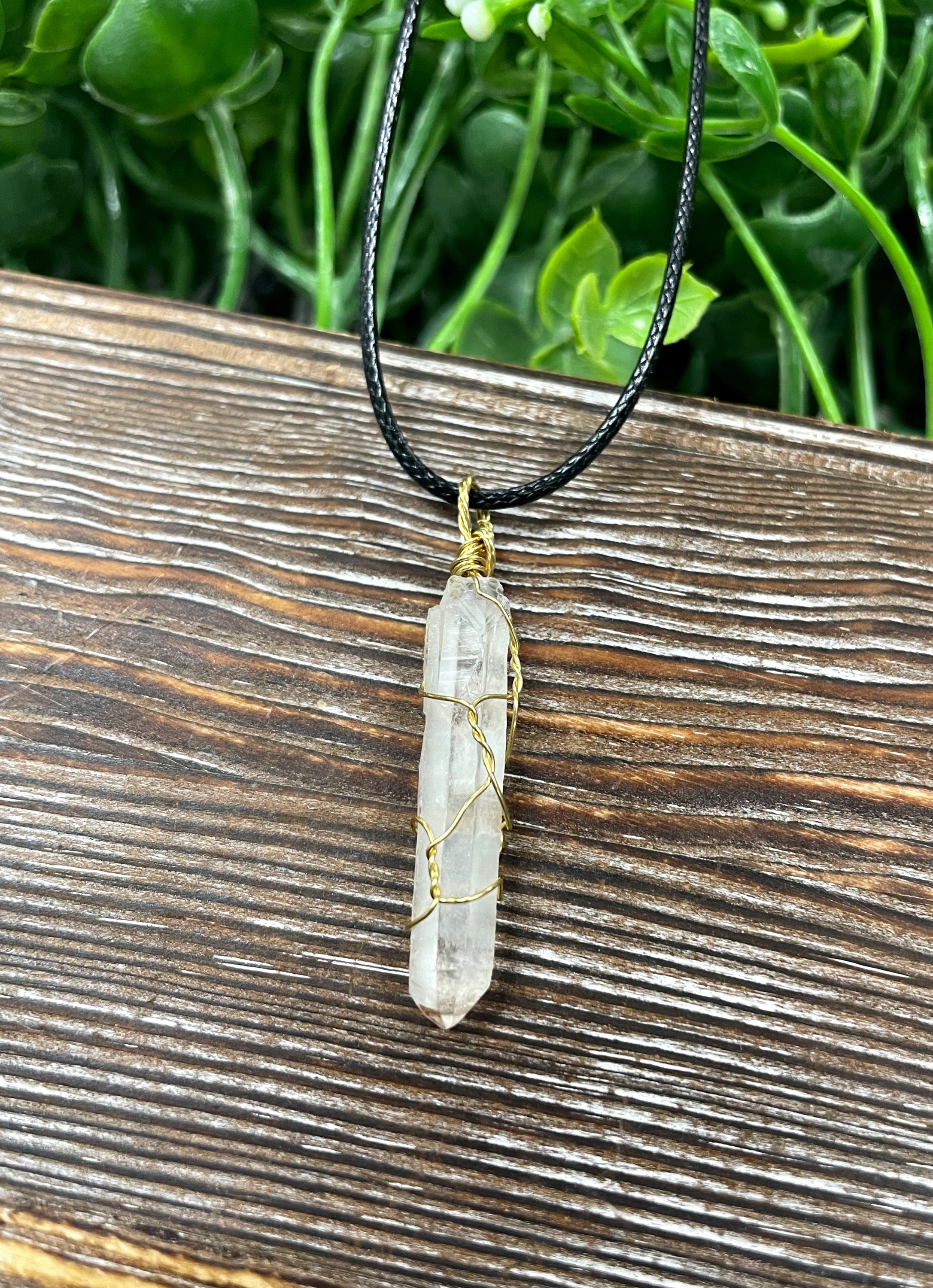 Wire Wrapped Clear Quartz Crystal Pendant with Brass Wire on a 21-inch cord, showcasing its antique finish and natural beauty.