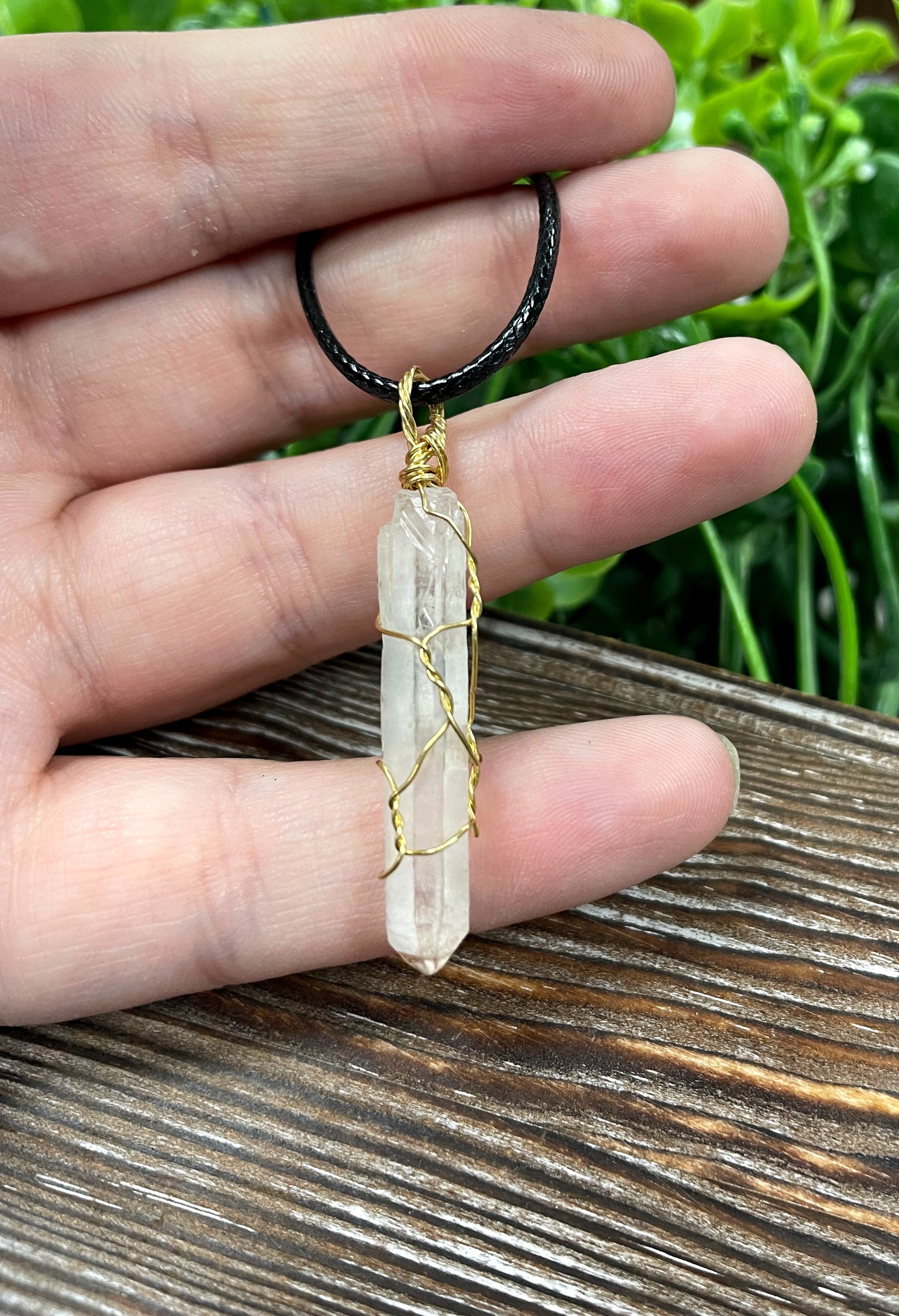 Wire Wrapped Clear Quartz Crystal Pendant with Brass Wire on a 21-inch cord, showcasing its antique finish and natural beauty.