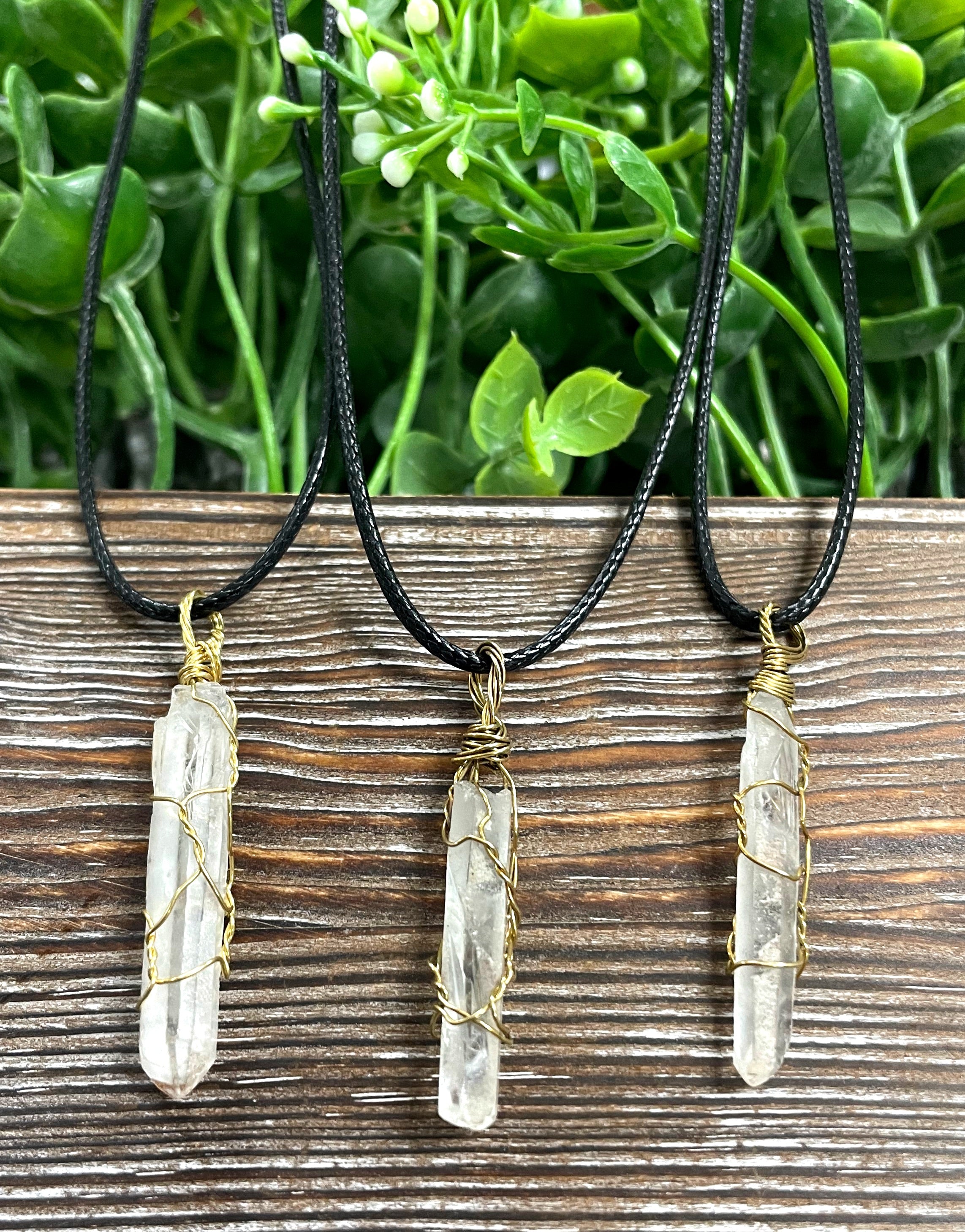 Wire Wrapped Clear Quartz Crystal Pendant with Brass Wire on a 21-inch cord, showcasing its antique finish and natural beauty.