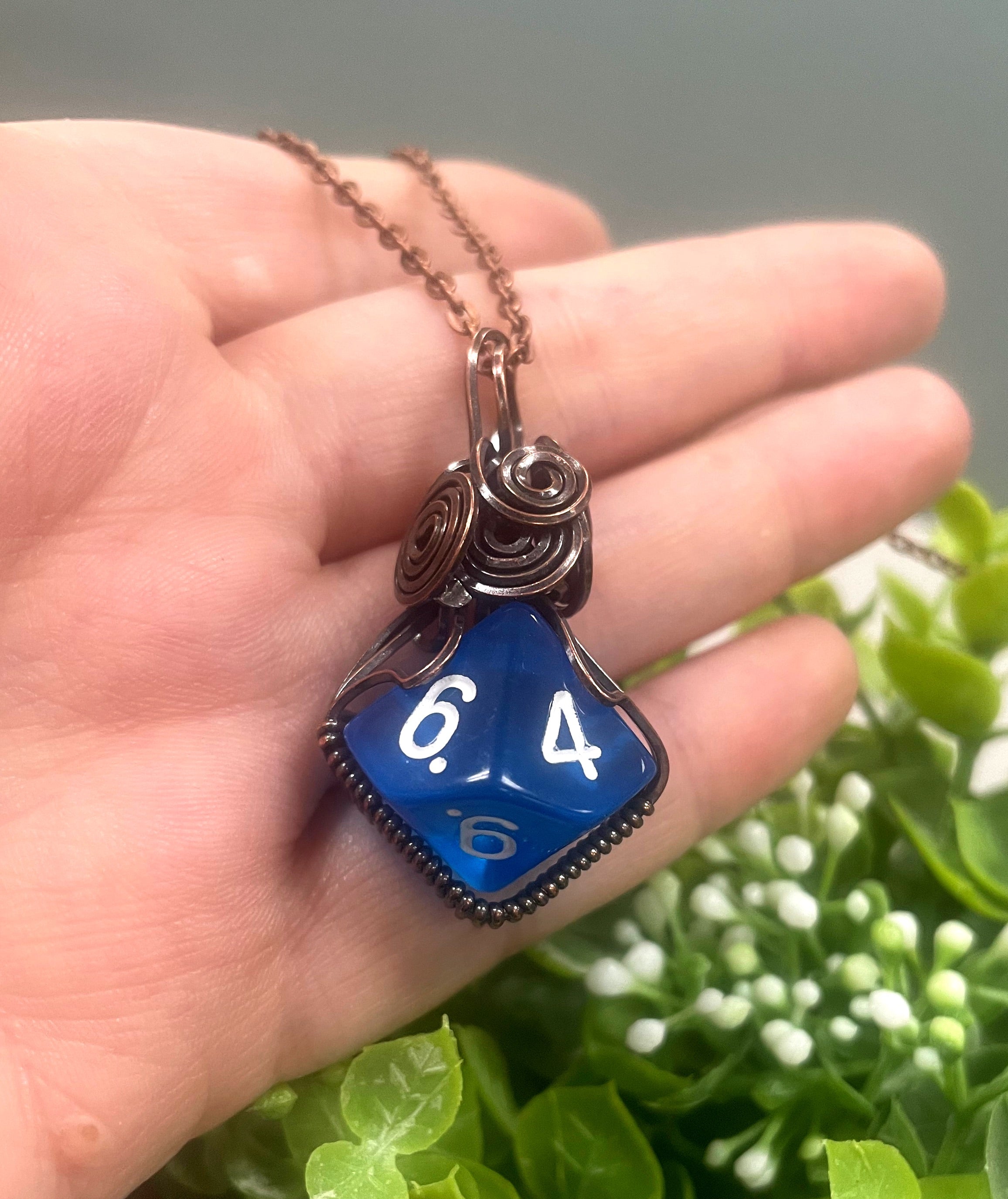 Wire Wrapped D10 Dice Pendant in blue, featuring oxidized copper wire and a suede leather cord, showcasing a unique gaming-inspired design.