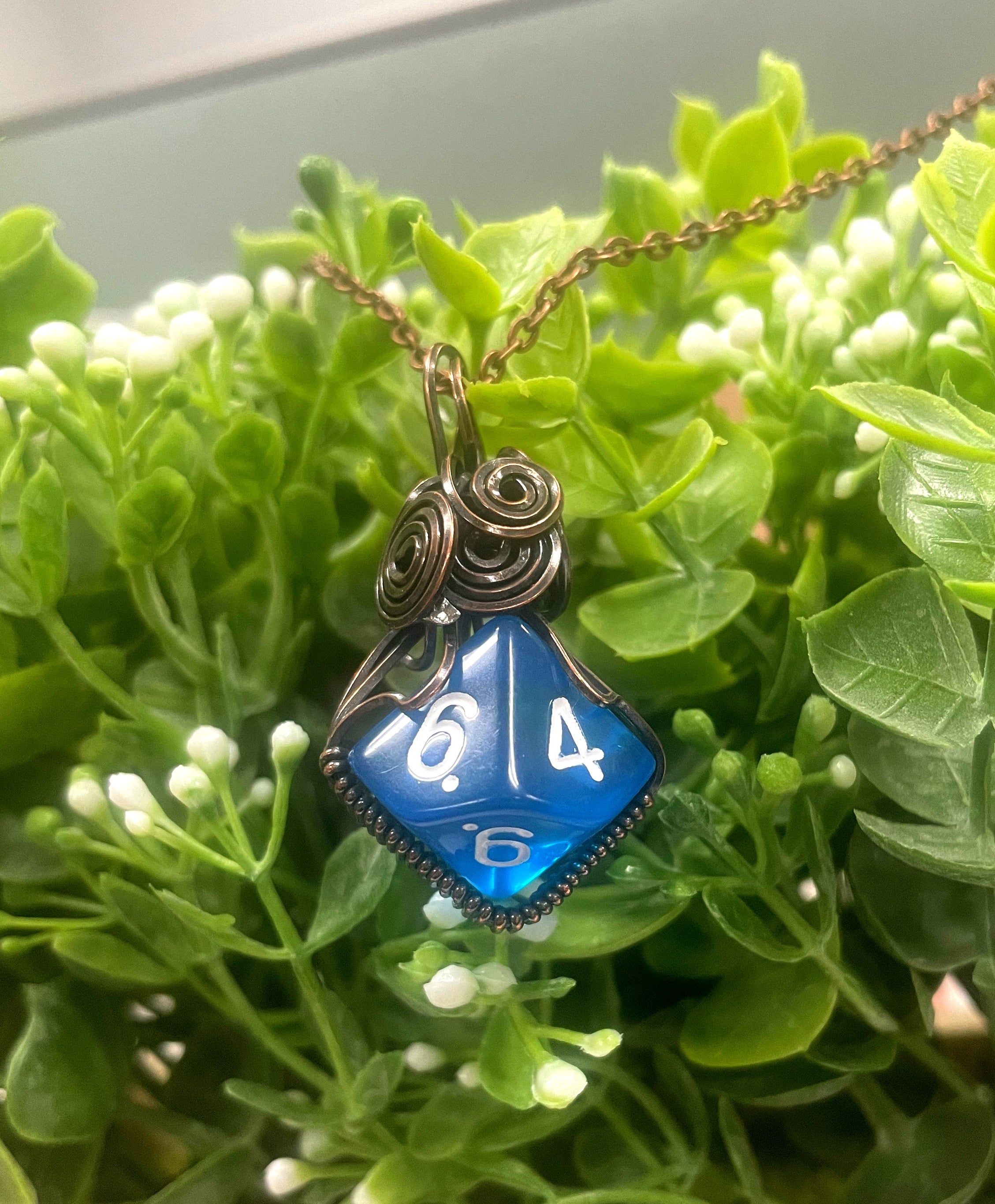 Wire Wrapped D10 Dice Pendant in blue, featuring oxidized copper wire and a suede leather cord, showcasing a unique gaming-inspired design.