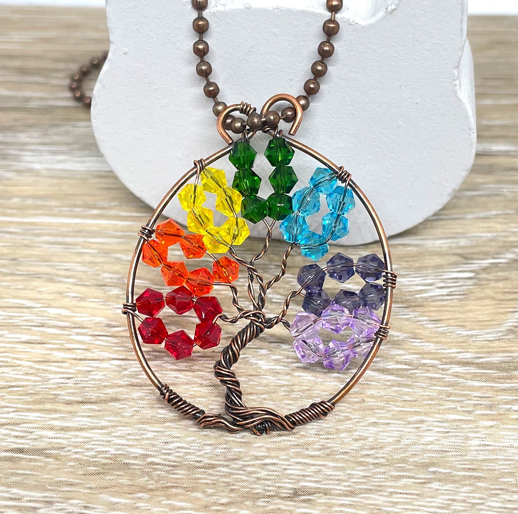 Wire Wrapped Rainbow Tree of Life Pendant featuring colorful glass crystals and oxidized copper wire on an 18-inch ball chain.