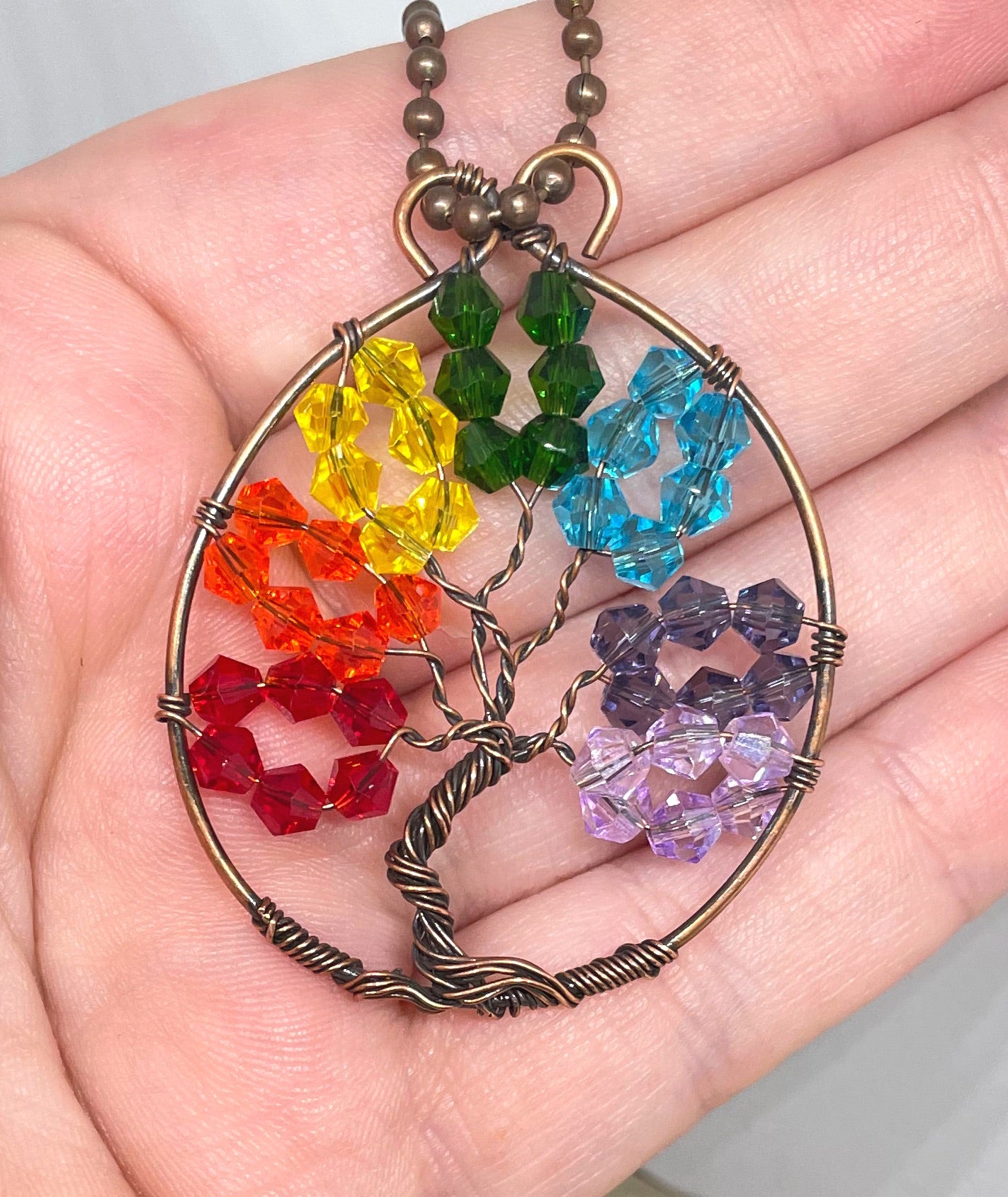 Wire Wrapped Rainbow Tree of Life Pendant featuring colorful glass crystals and oxidized copper wire on an 18-inch ball chain.