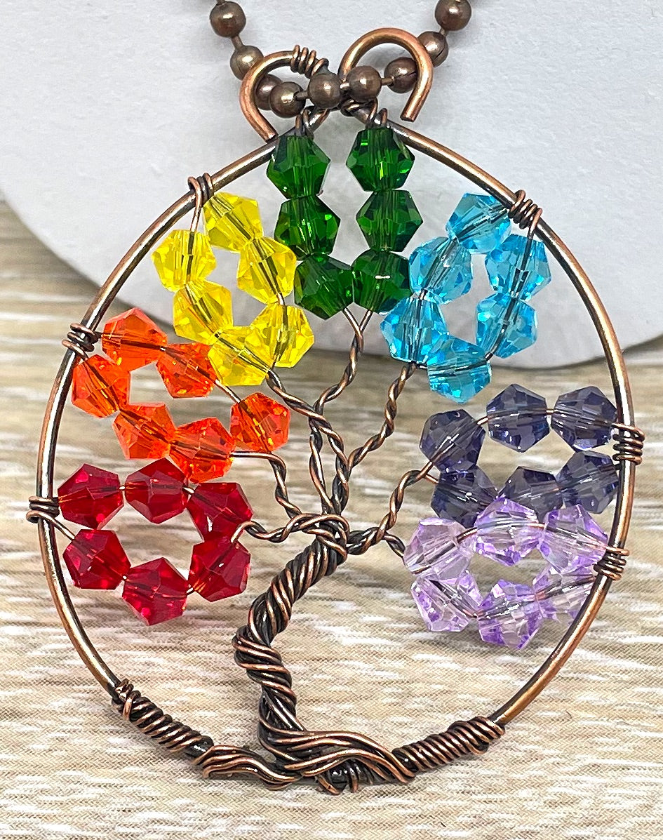 Wire Wrapped Rainbow Tree of Life Pendant featuring colorful glass crystals and oxidized copper wire on an 18-inch ball chain.