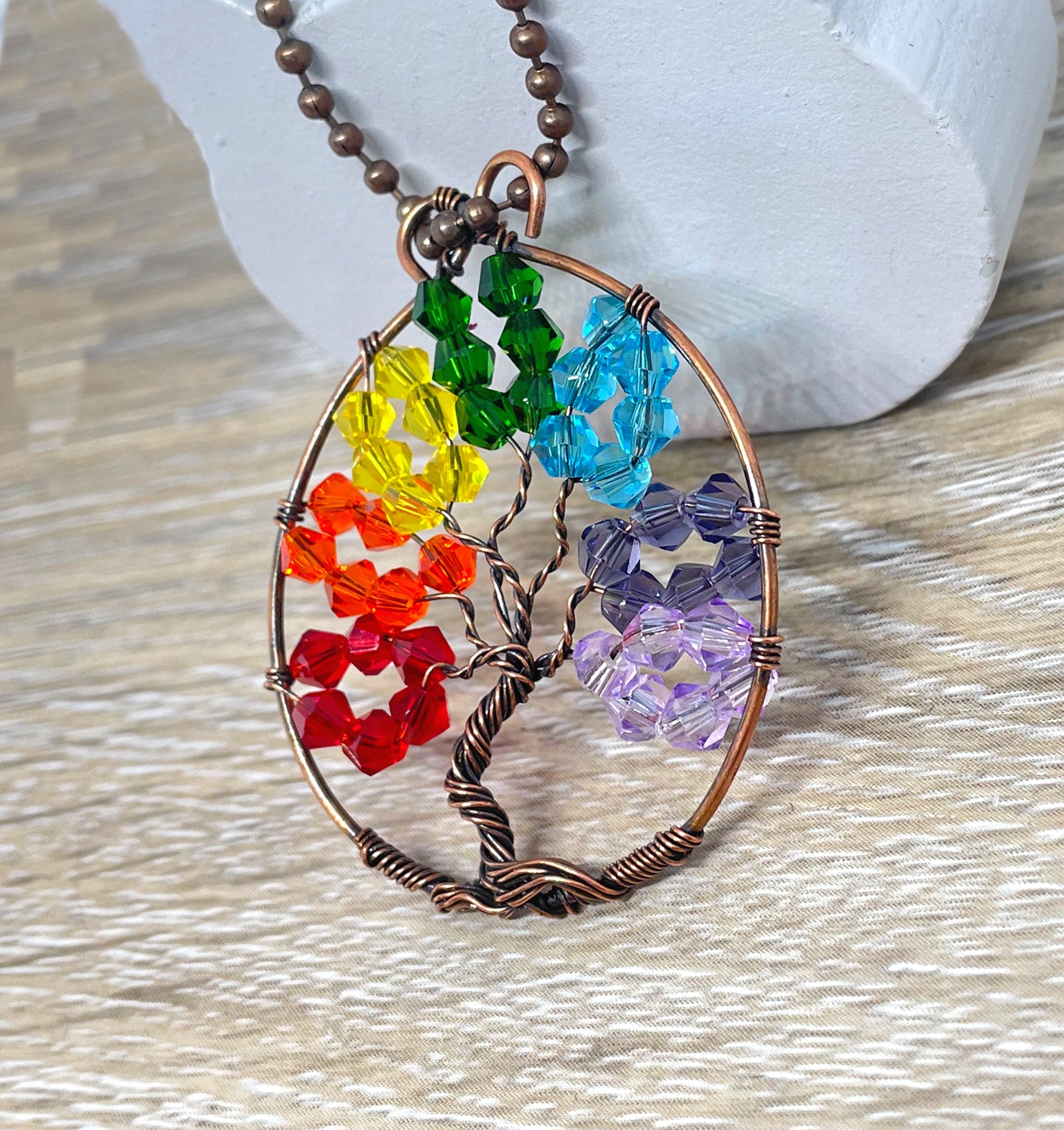 Wire Wrapped Rainbow Tree of Life Pendant featuring colorful glass crystals and oxidized copper wire on an 18-inch ball chain.