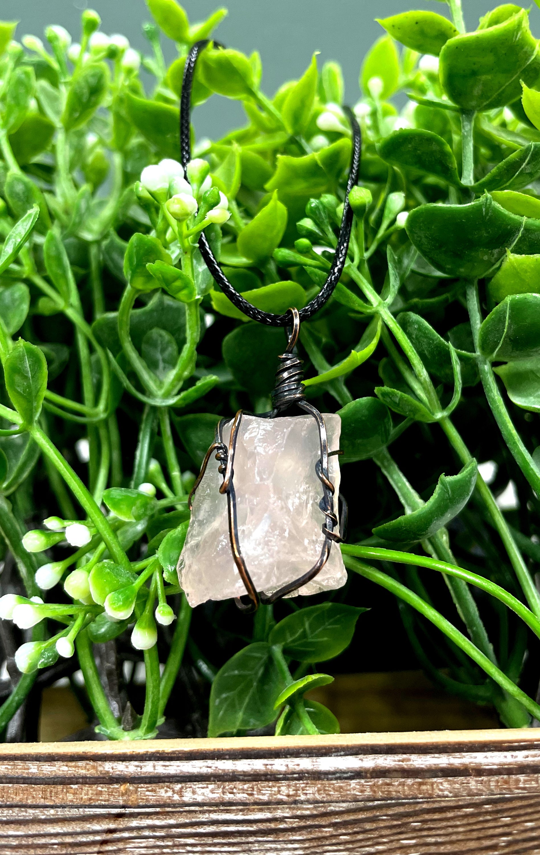 Wire Wrapped Rough Rose Quartz Chunk Gemstone Pendant with oxidized copper wire on a 21-inch cord, showcasing its natural beauty and antique finish.