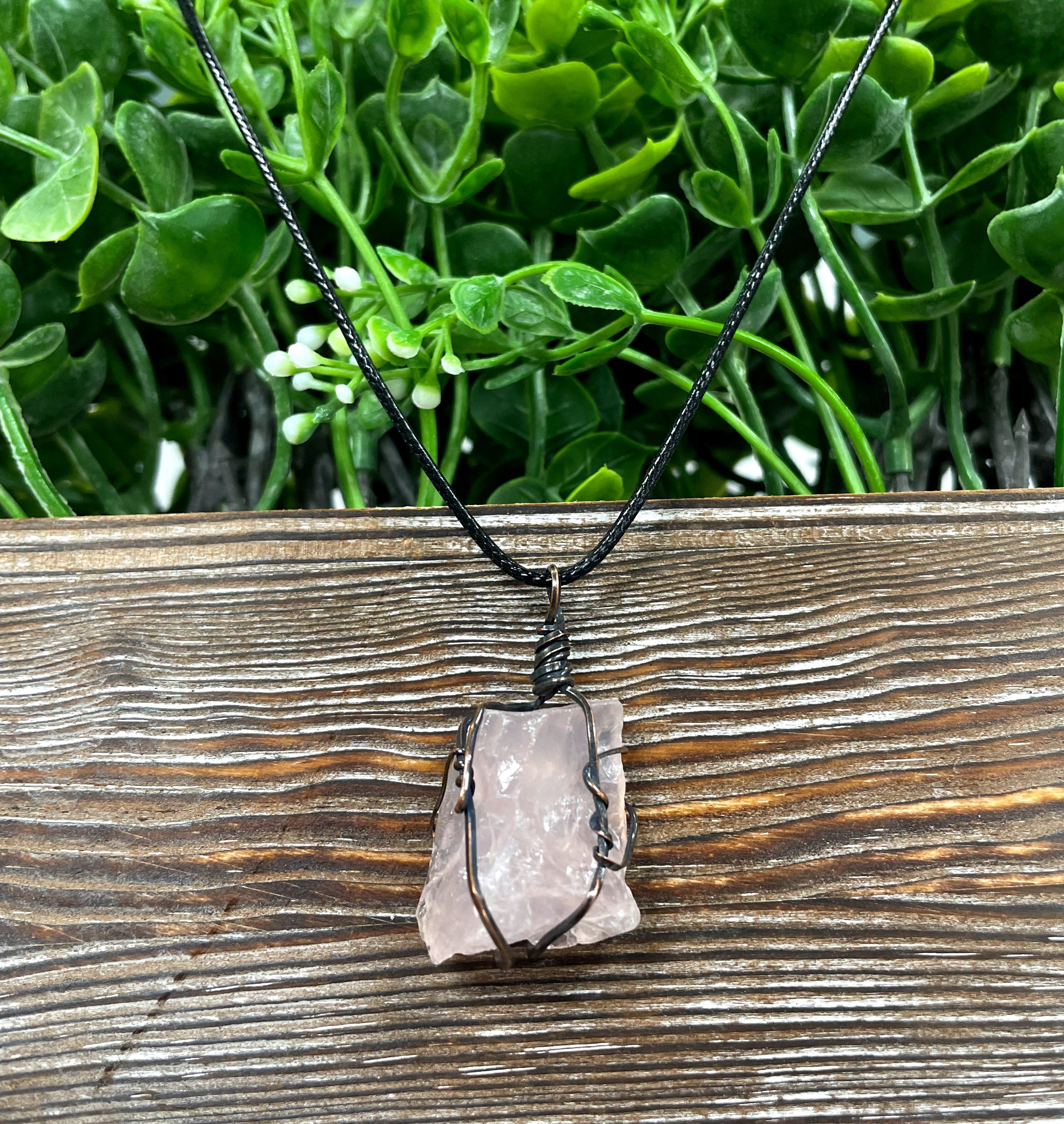 Wire Wrapped Rough Rose Quartz Chunk Gemstone Pendant with oxidized copper wire on a 21-inch cord, showcasing its natural beauty and antique finish.