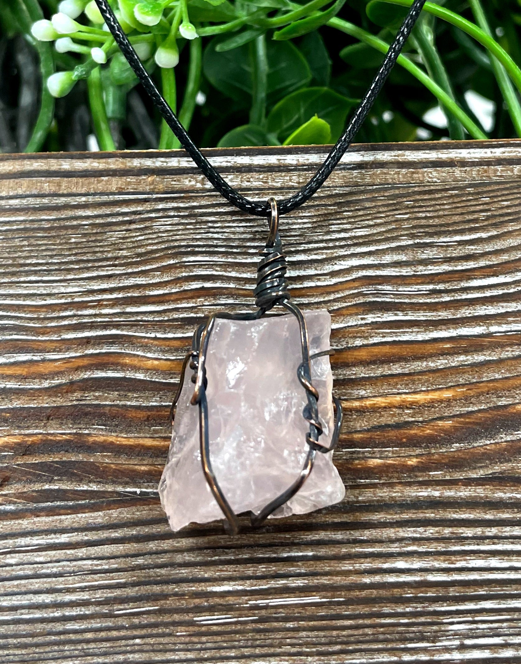 Wire Wrapped Rough Rose Quartz Chunk Gemstone Pendant with oxidized copper wire on a 21-inch cord, showcasing its natural beauty and antique finish.