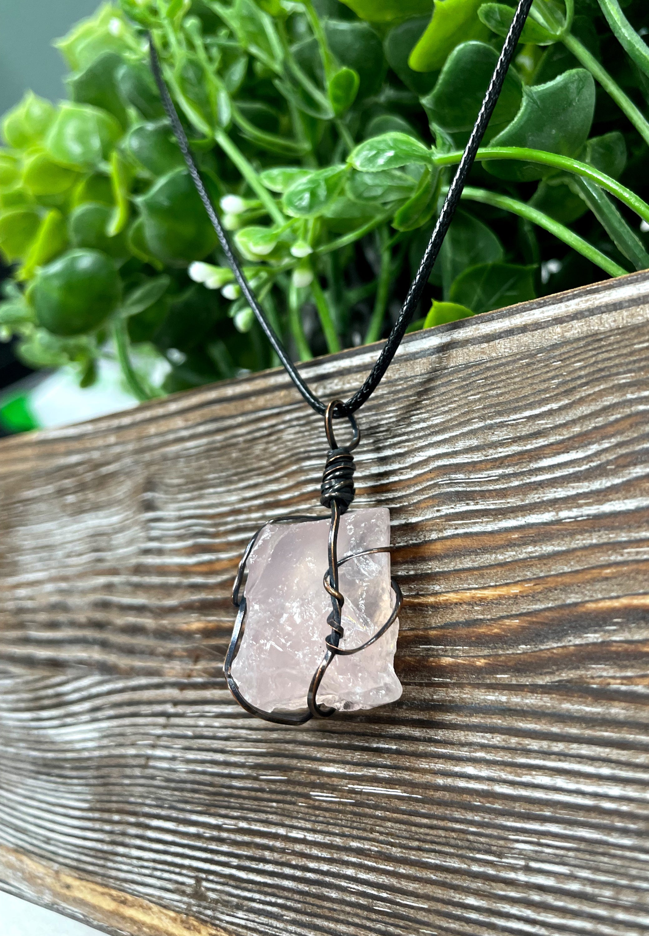 Wire Wrapped Rough Rose Quartz Chunk Gemstone Pendant with oxidized copper wire on a 21-inch cord, showcasing its natural beauty and antique finish.