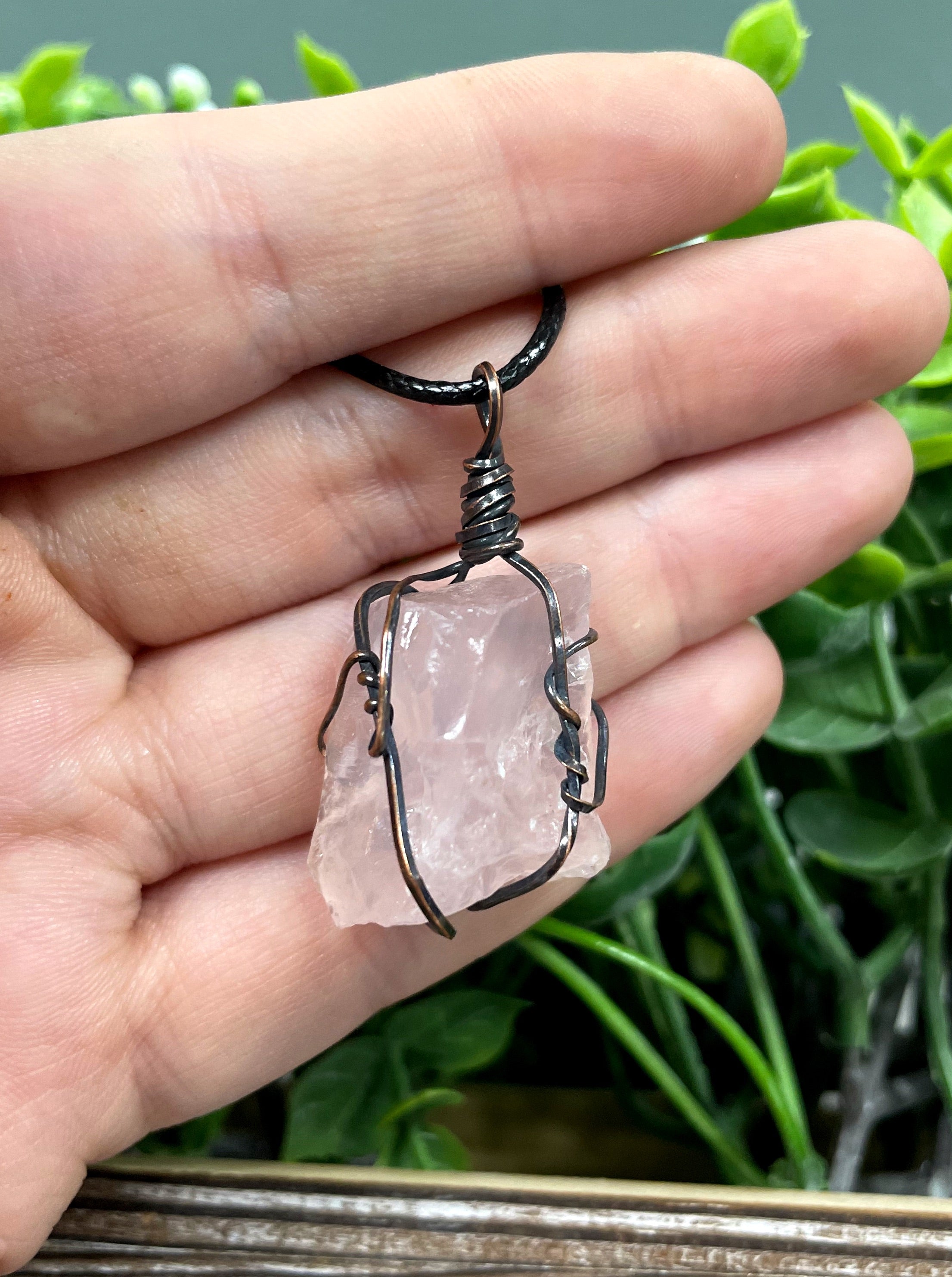 Wire Wrapped Rough Rose Quartz Chunk Gemstone Pendant with oxidized copper wire on a 21-inch cord, showcasing its natural beauty and antique finish.