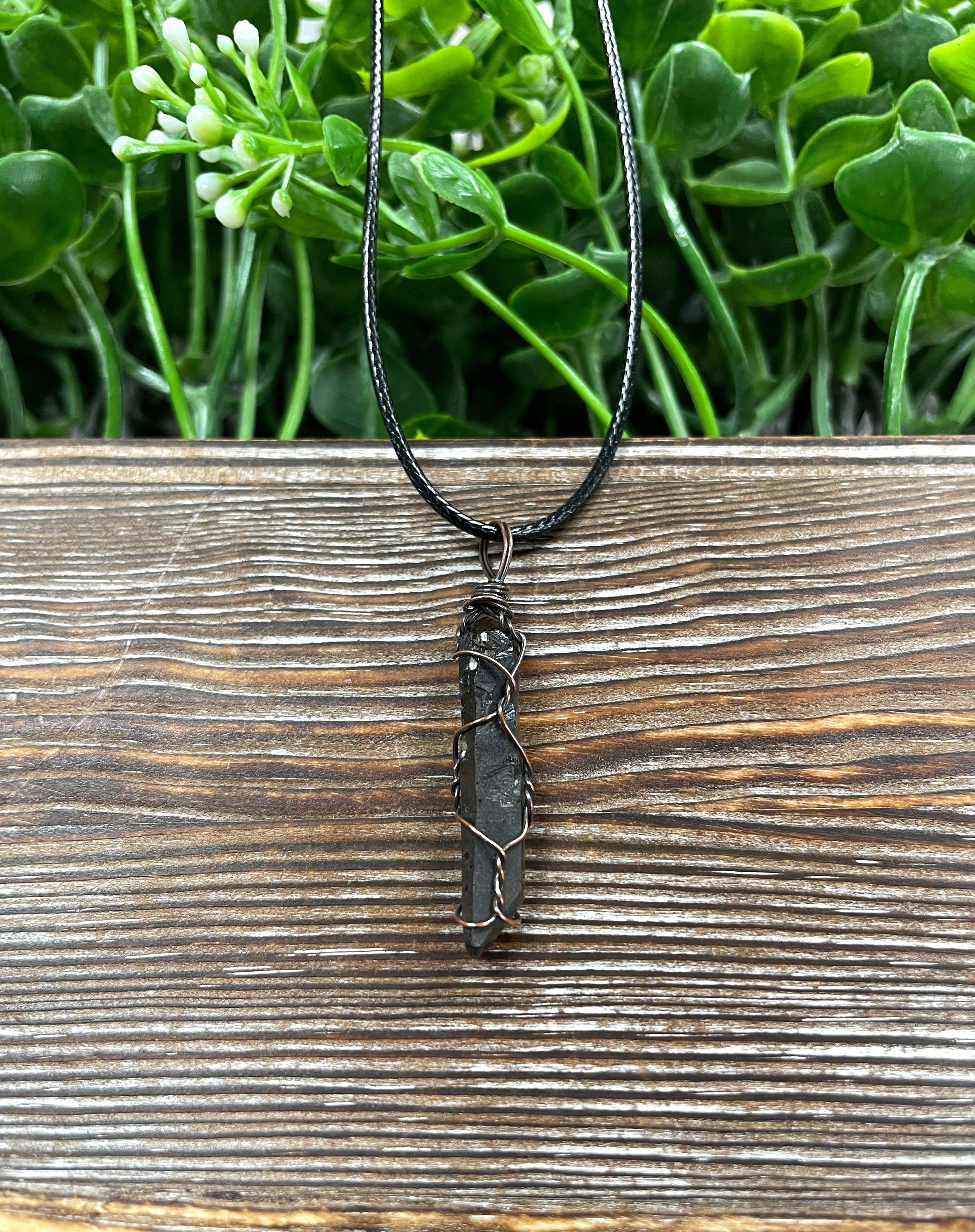 Wire Wrapped Smoky Quartz Crystal Pendant with oxidized copper wire on a 21-inch cord, showcasing its antique look and polished finish.