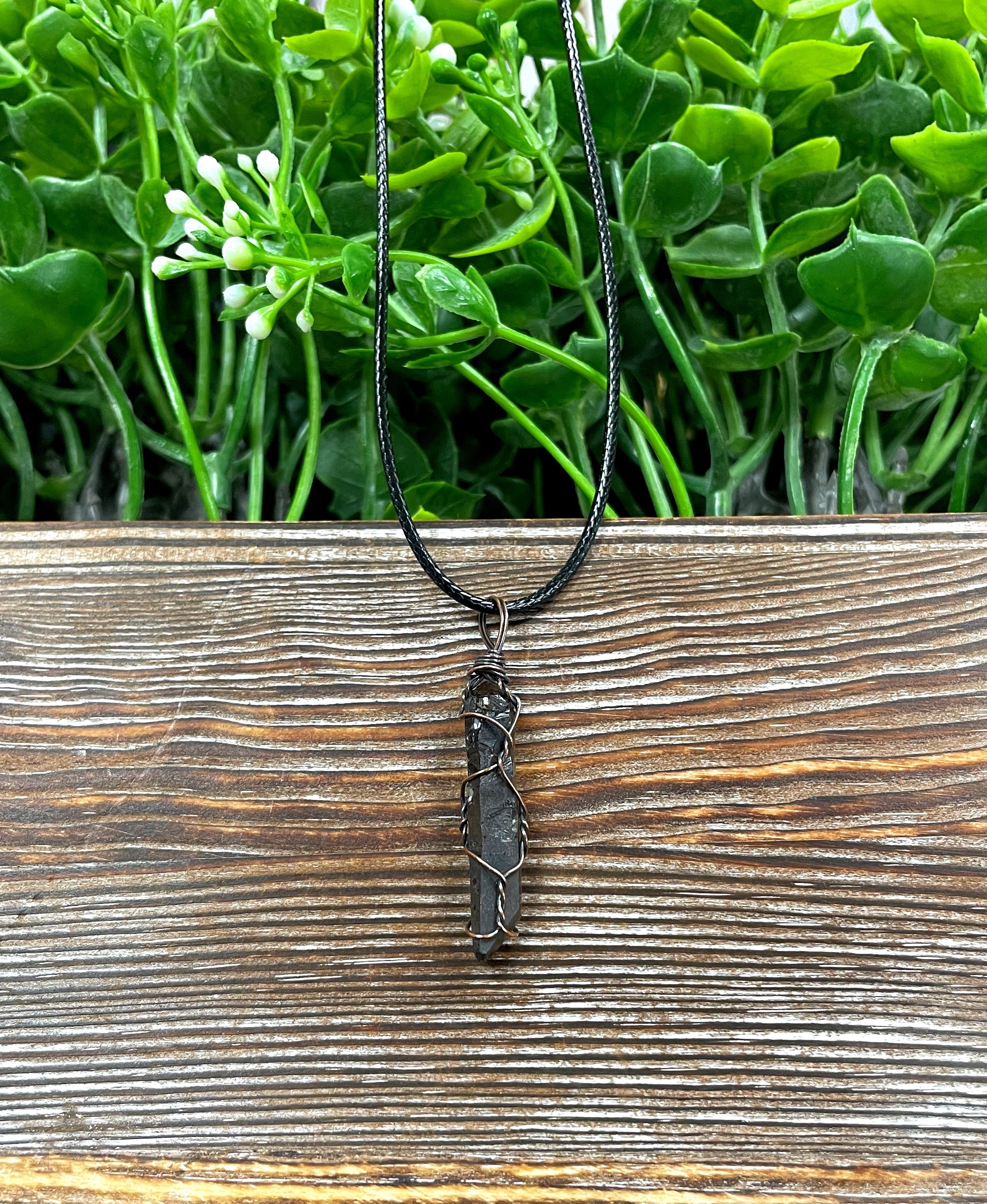 Wire Wrapped Smoky Quartz Crystal Pendant with oxidized copper wire on a 21-inch cord, showcasing its antique look and polished finish.