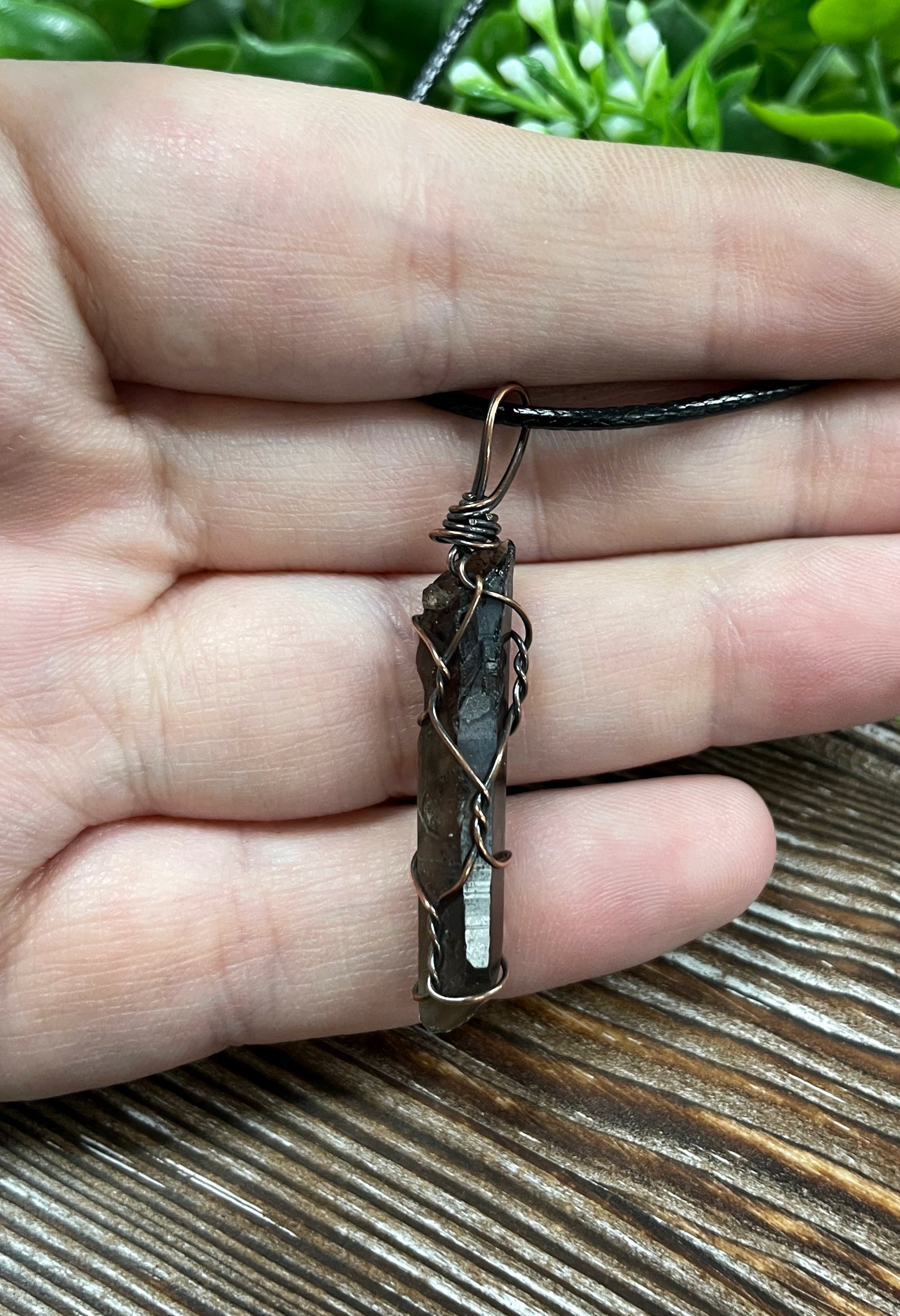 Wire Wrapped Smoky Quartz Crystal Pendant with oxidized copper wire on a 21-inch cord, showcasing its antique look and polished finish.