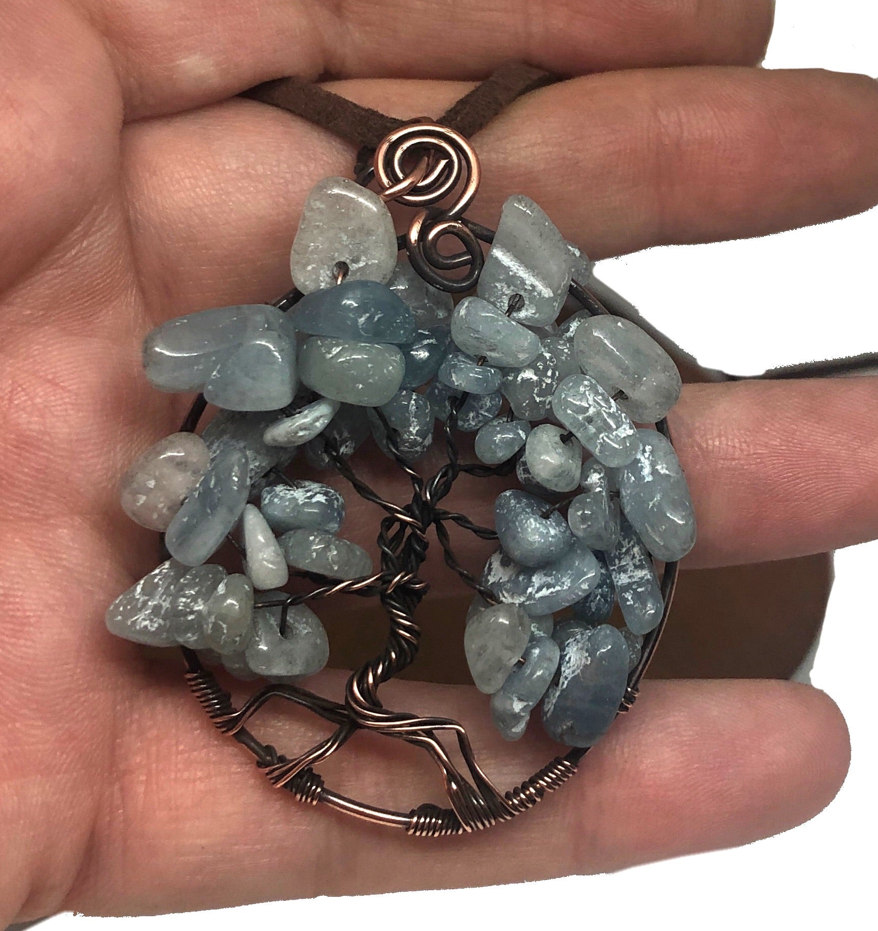 Wire Wrapped Tree of Life Pendant featuring larimar gemstones on a suede leather cord, showcasing intricate oxidized copper wire wrapping.