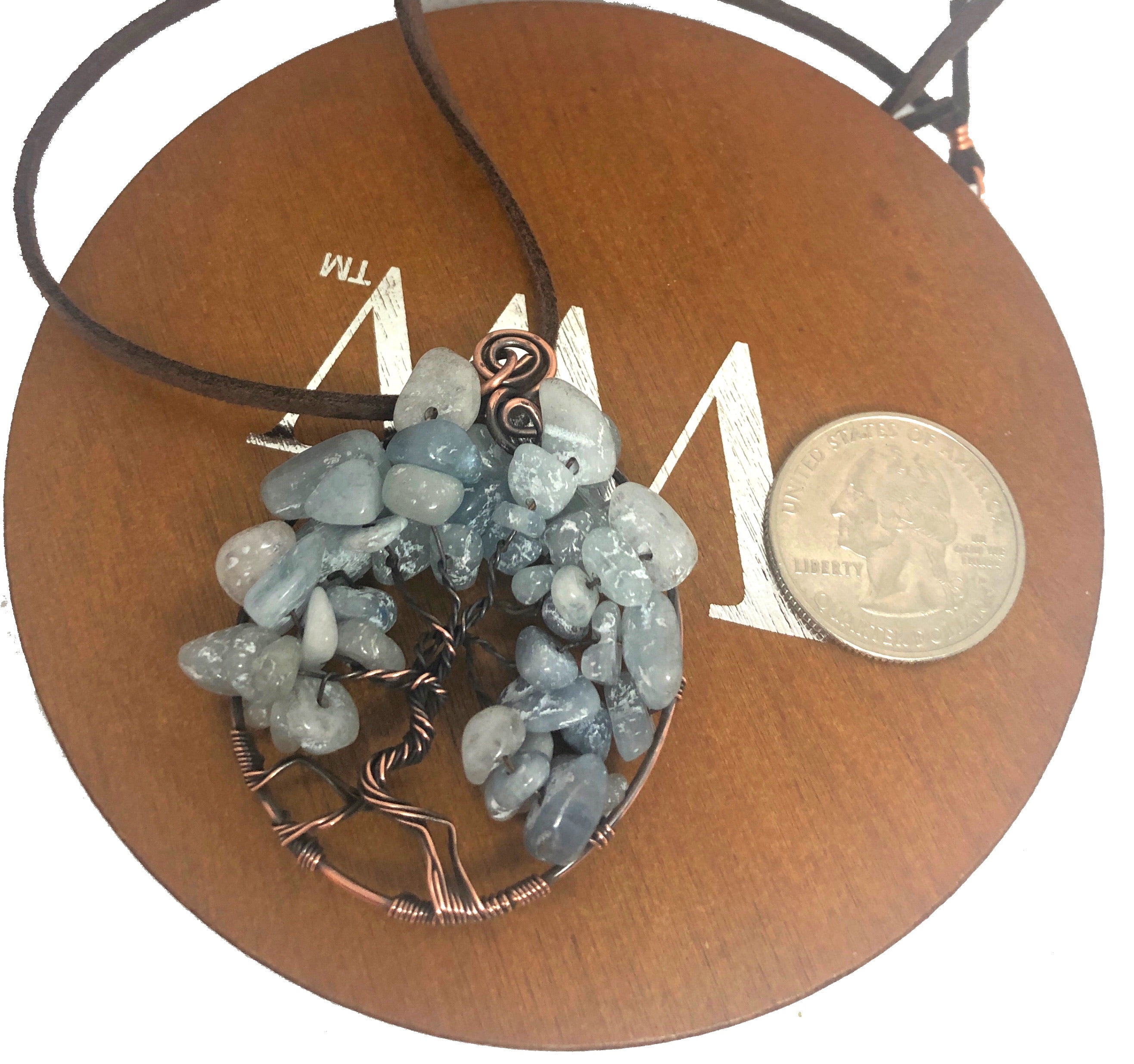 Wire Wrapped Tree of Life Pendant featuring larimar gemstones on a suede leather cord, showcasing intricate oxidized copper wire wrapping.