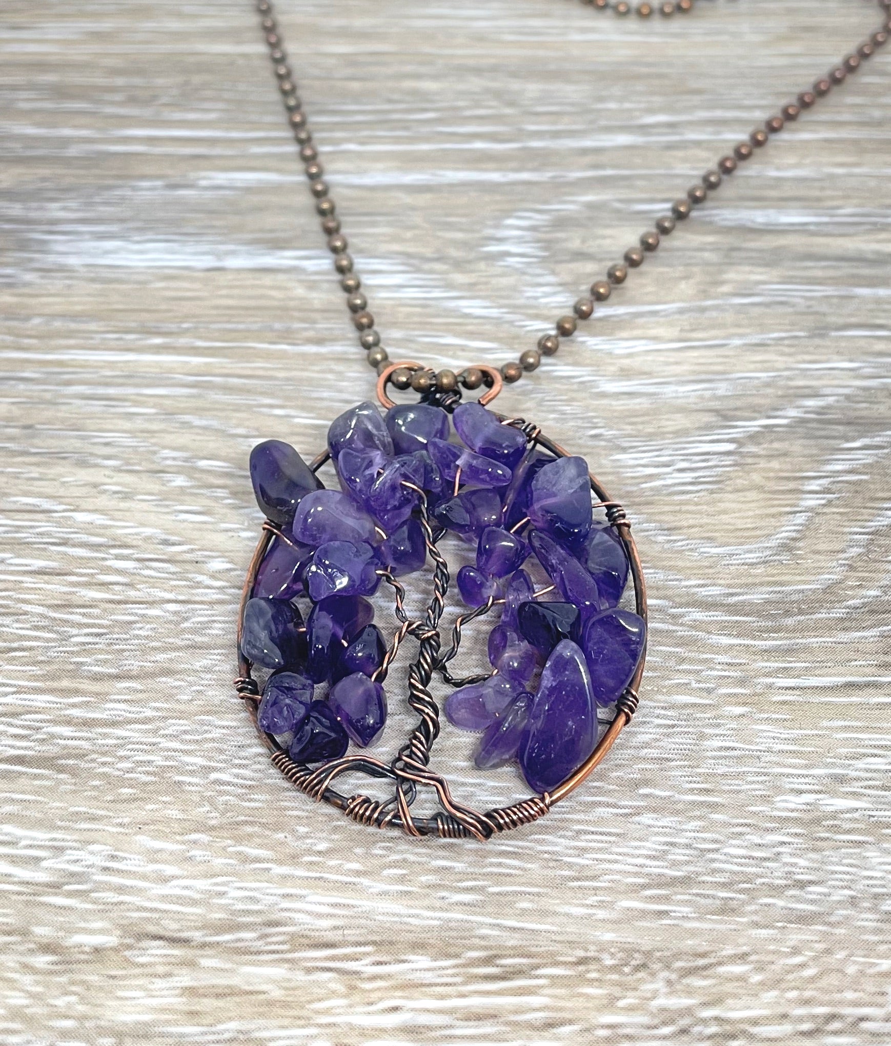 Wire Wrapped Tree of Life Pendant featuring Amethyst gemstones, crafted with oxidized copper wire on an 18-inch ball chain.