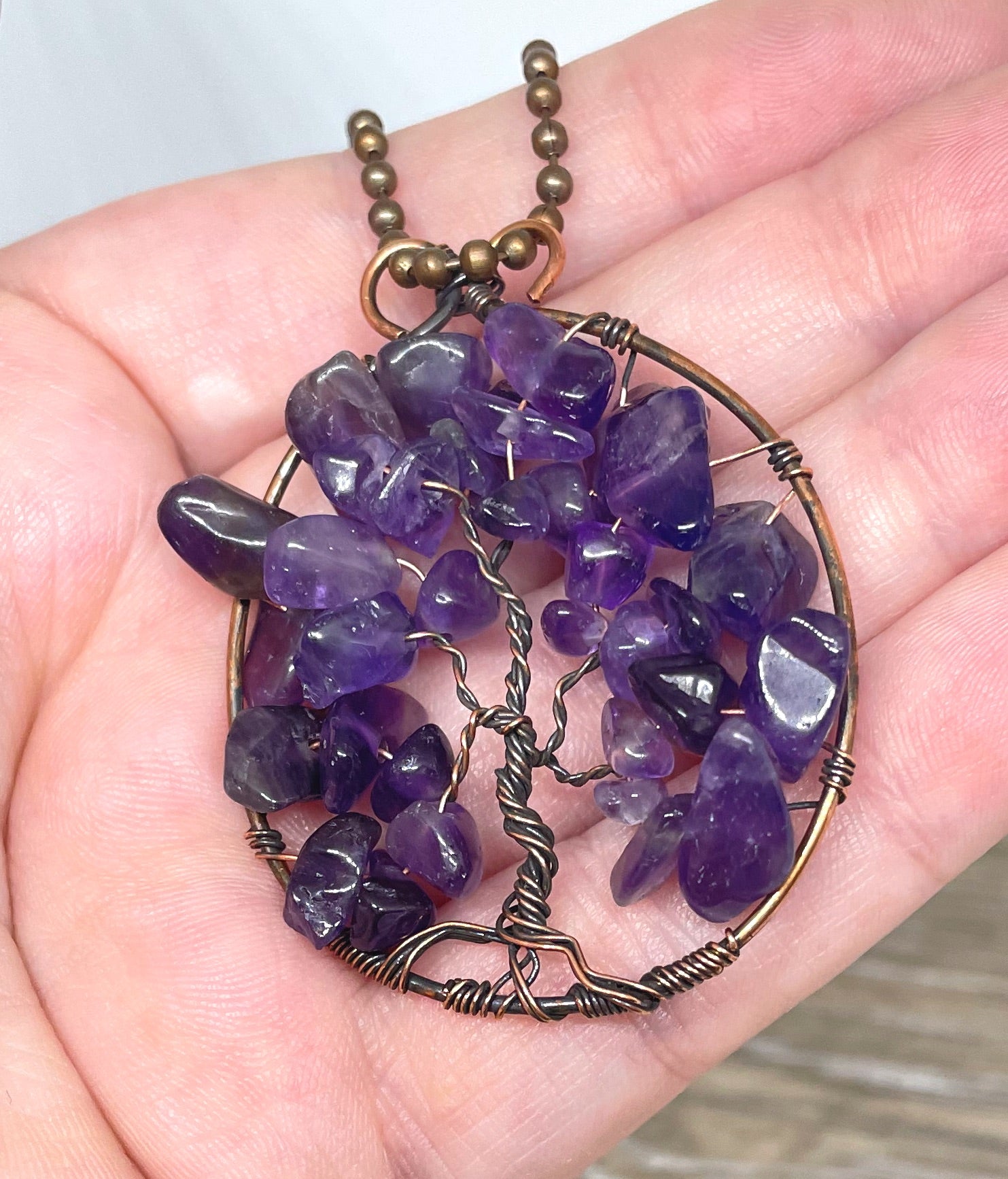 Wire Wrapped Tree of Life Pendant featuring Amethyst gemstones, crafted with oxidized copper wire on an 18-inch ball chain.