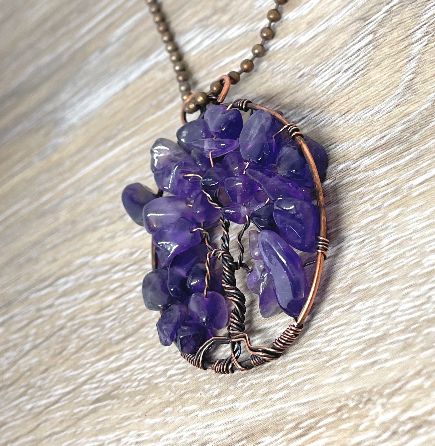 Wire Wrapped Tree of Life Pendant featuring Amethyst gemstones, crafted with oxidized copper wire on an 18-inch ball chain.