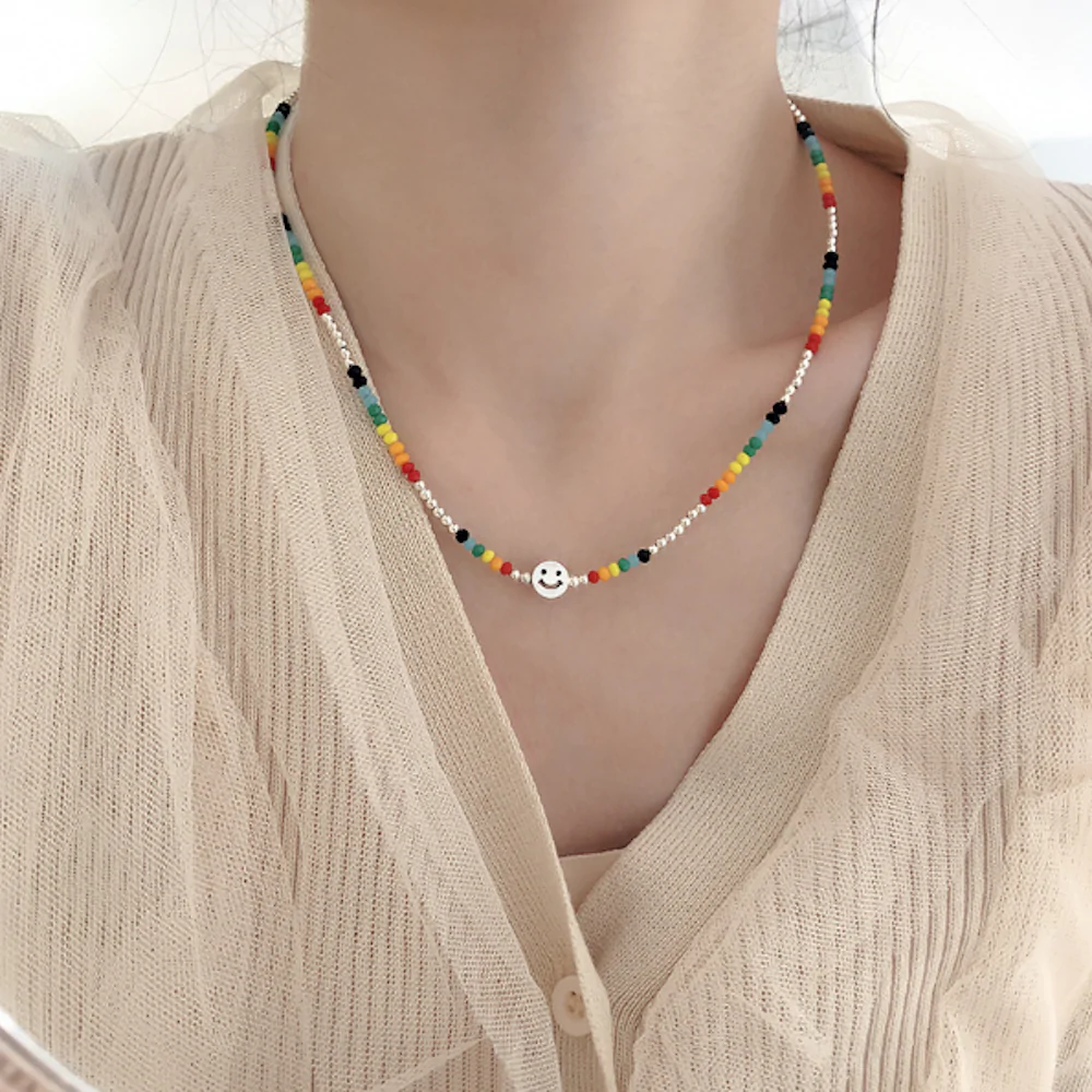 A vibrant women's beaded necklace featuring a happy face design, perfect for summer fashion.