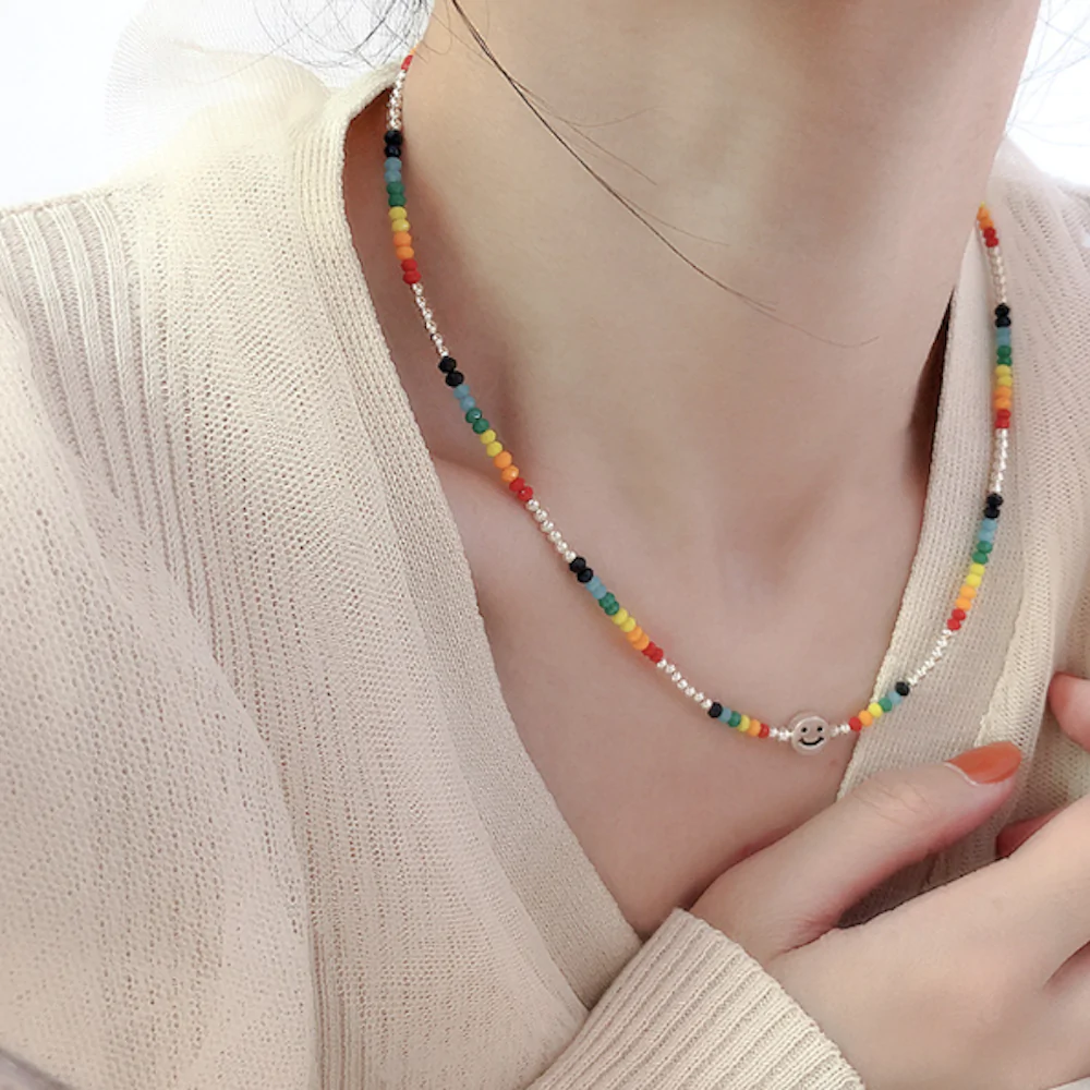 A vibrant women's beaded necklace featuring a happy face design, perfect for summer fashion.