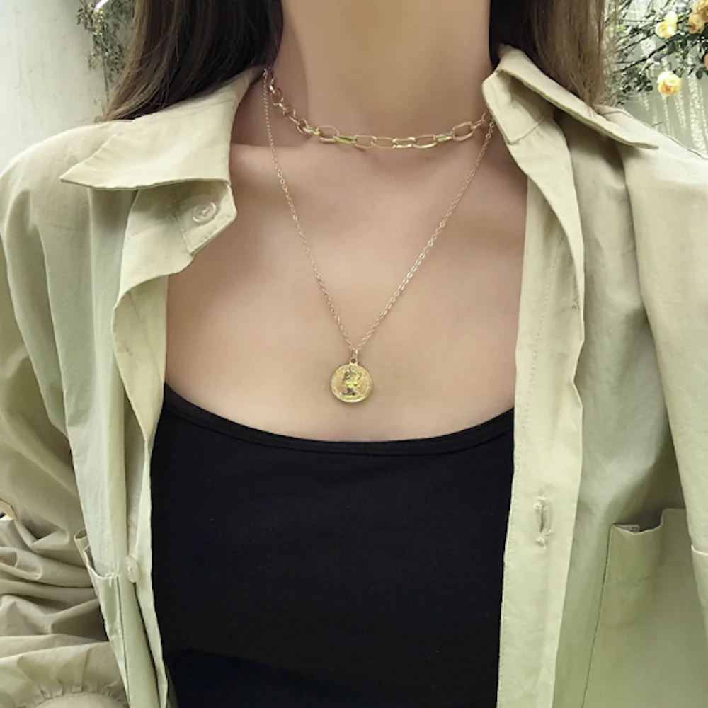 Womens Layered Look Choker Necklace featuring a gold-plated finish and a unique coin pendant, elegantly displayed on a soft background.