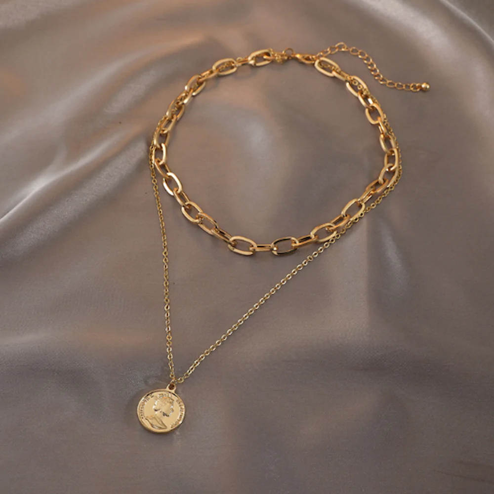 Womens Layered Look Choker Necklace featuring a gold-plated finish and a unique coin pendant, elegantly displayed on a soft background.