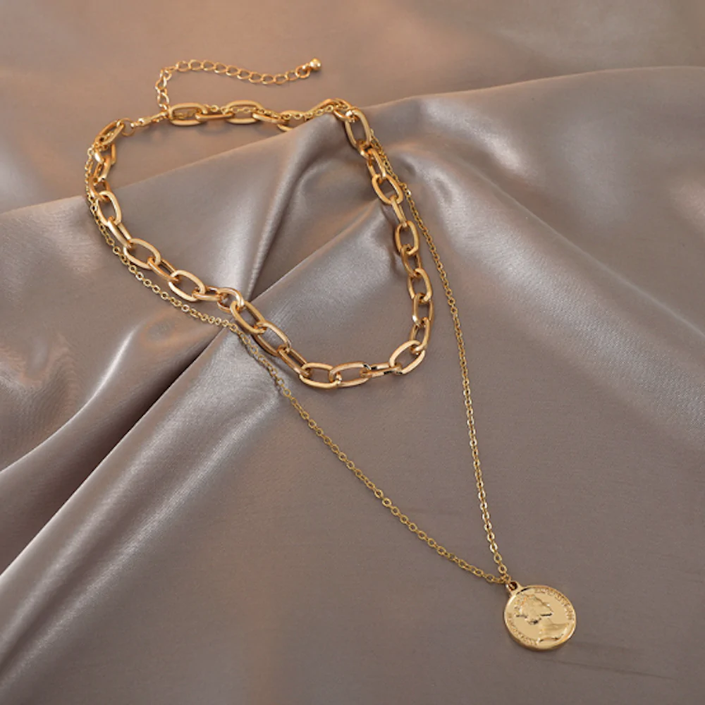 Womens Layered Look Choker Necklace featuring a gold-plated finish and a unique coin pendant, elegantly displayed on a soft background.