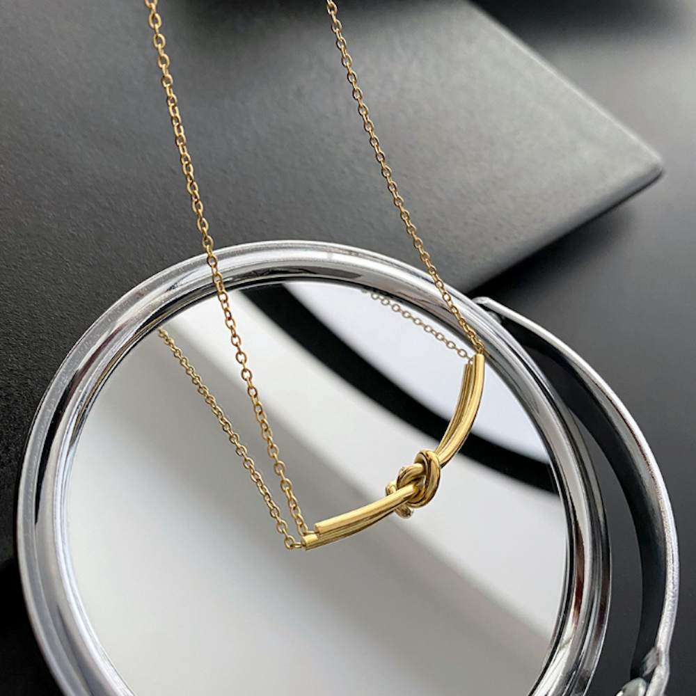 Womens Tie The Knot Necklace featuring a gold plated alloy design, adjustable length, and a simple yet elegant knot motif.