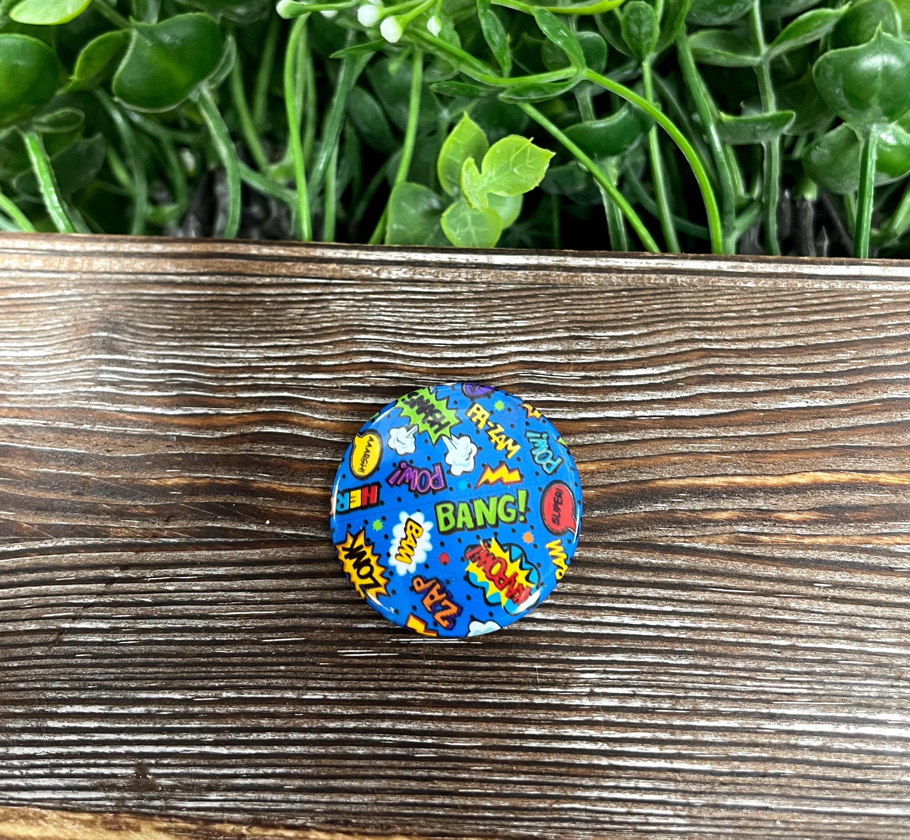 Zap Bang Pow graphic art button pin, 1.25 inches, featuring a vibrant comic book style design.