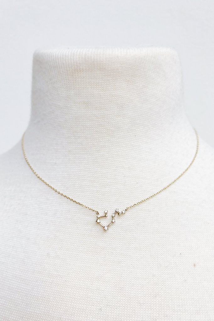 Zodiac Collection Necklace featuring 12 zodiac signs in gold dipped brass with cubic zirconia accents, elegantly displayed.