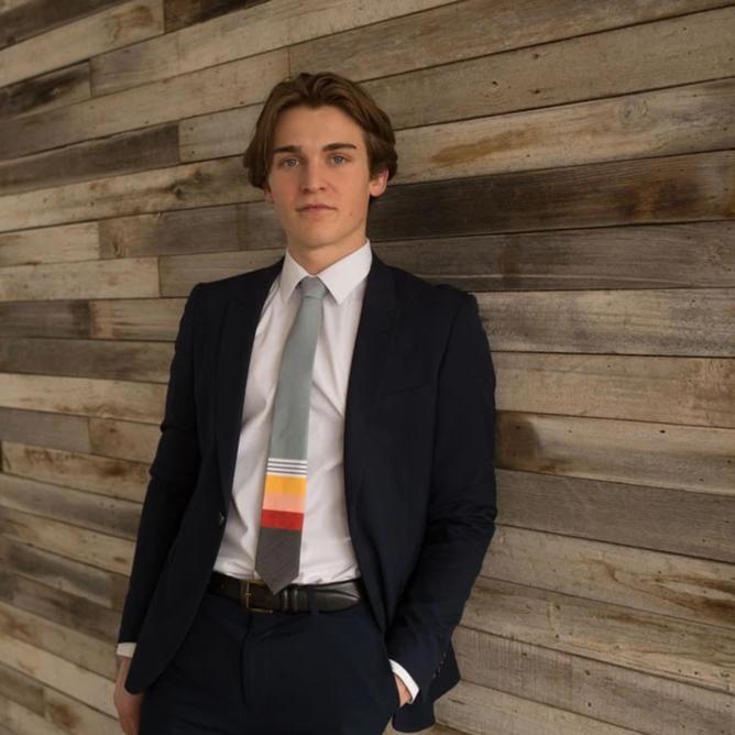 A vibrant 70's Sunset Colorblock Tie featuring mustard yellow, peach, and red colors, made from boardshort material.