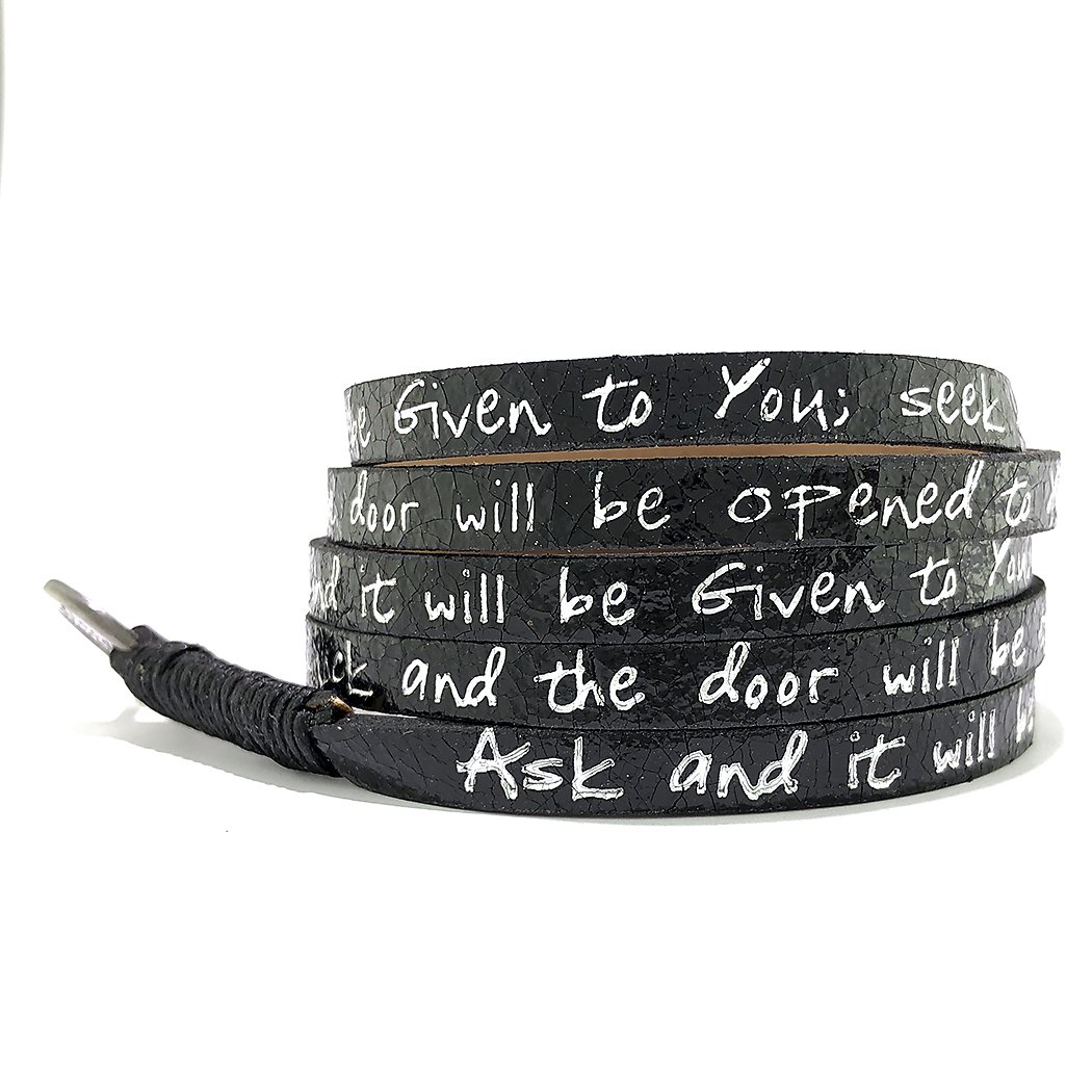 Metallic black wrap bracelet featuring Matthew 7:7 scripture, designed for everyday wear as a reminder of faith.